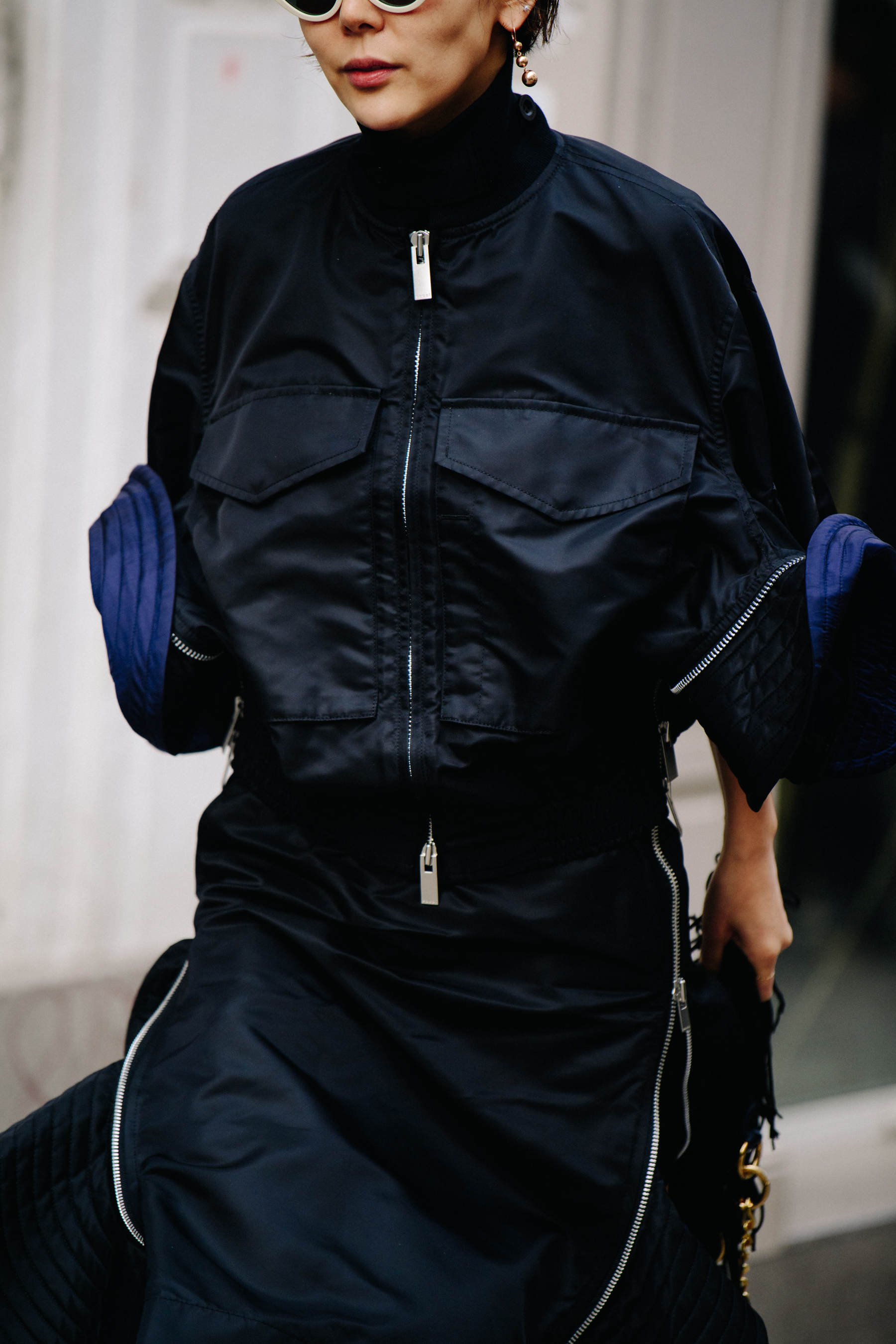 Asian woman wearing blue and black jacket