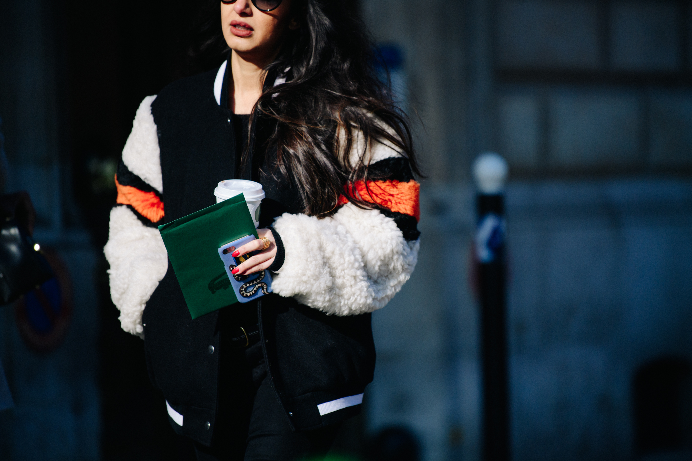 Woman wearing shearling varsity jacket