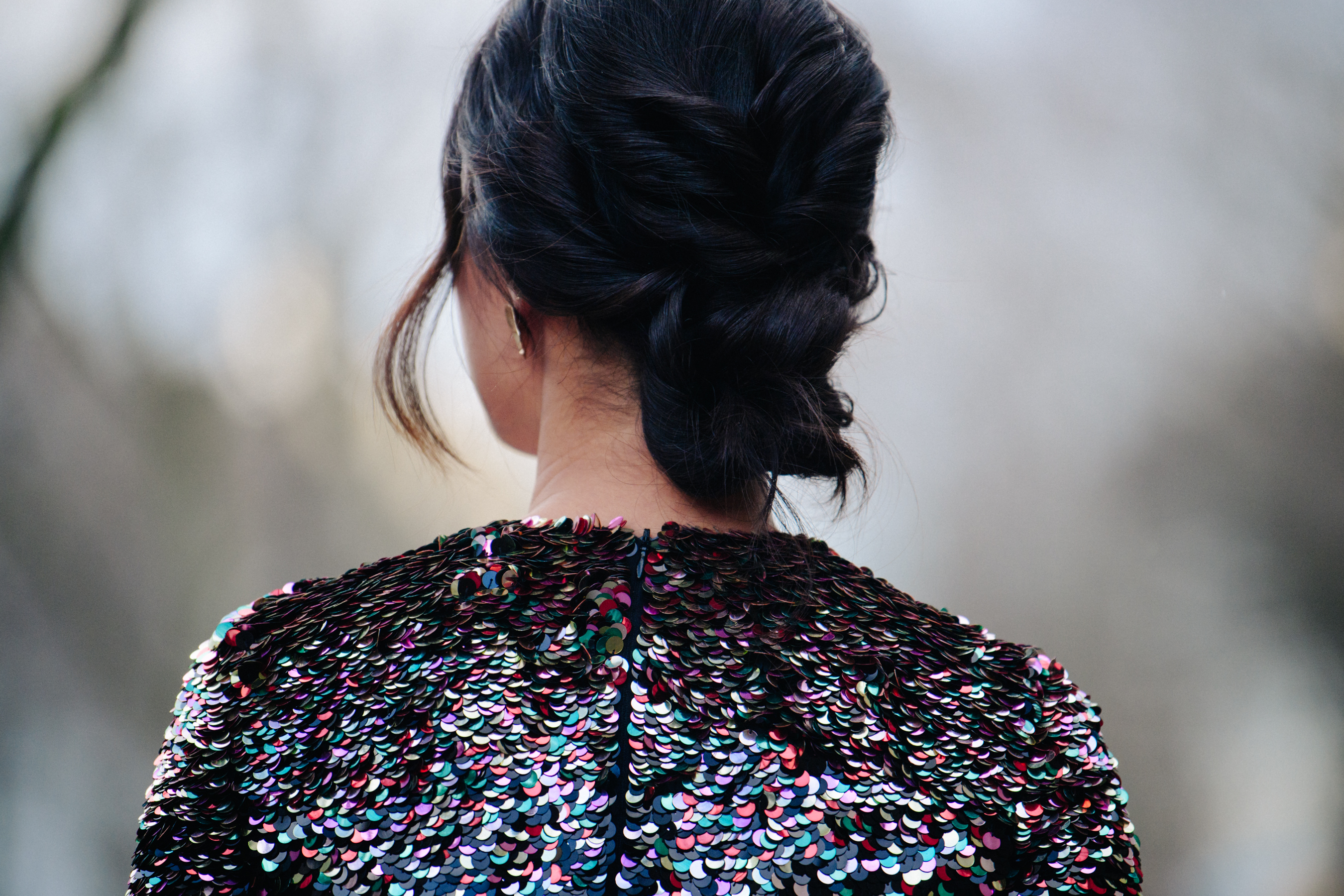 Asian woman wearing sequin top