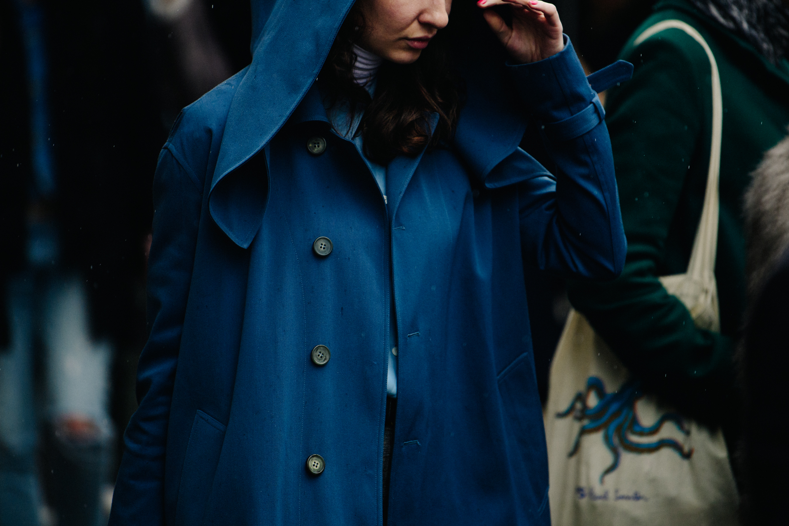 Woman wearing blue hooded coat