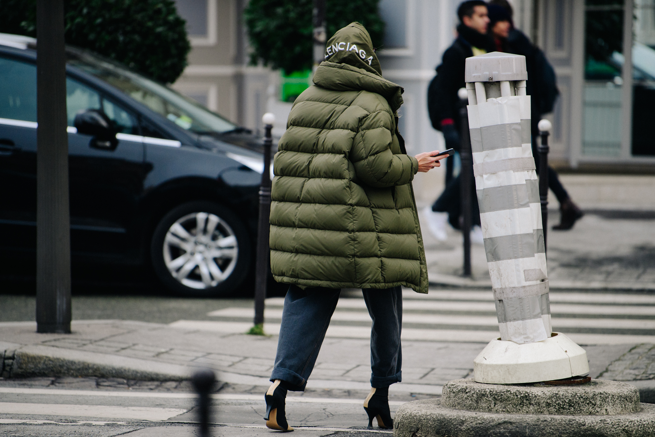 Woman wearing green Balenciaga coat