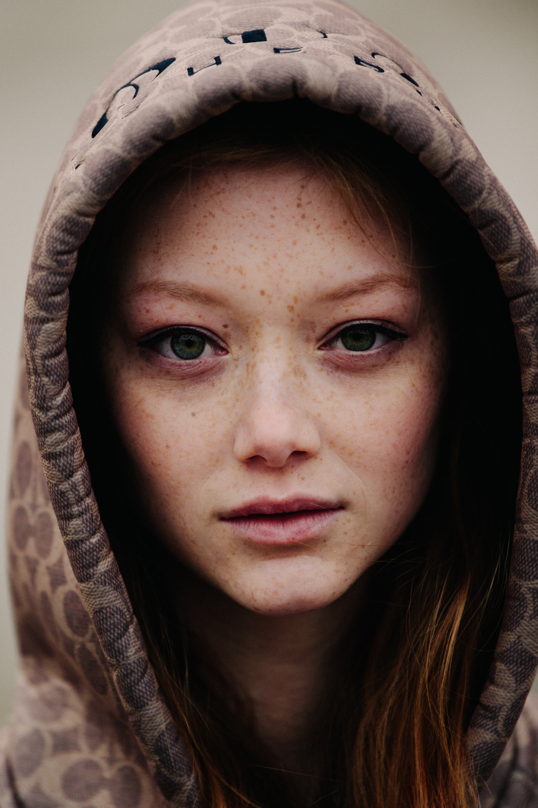 Portrait of model wearing brown hoodie