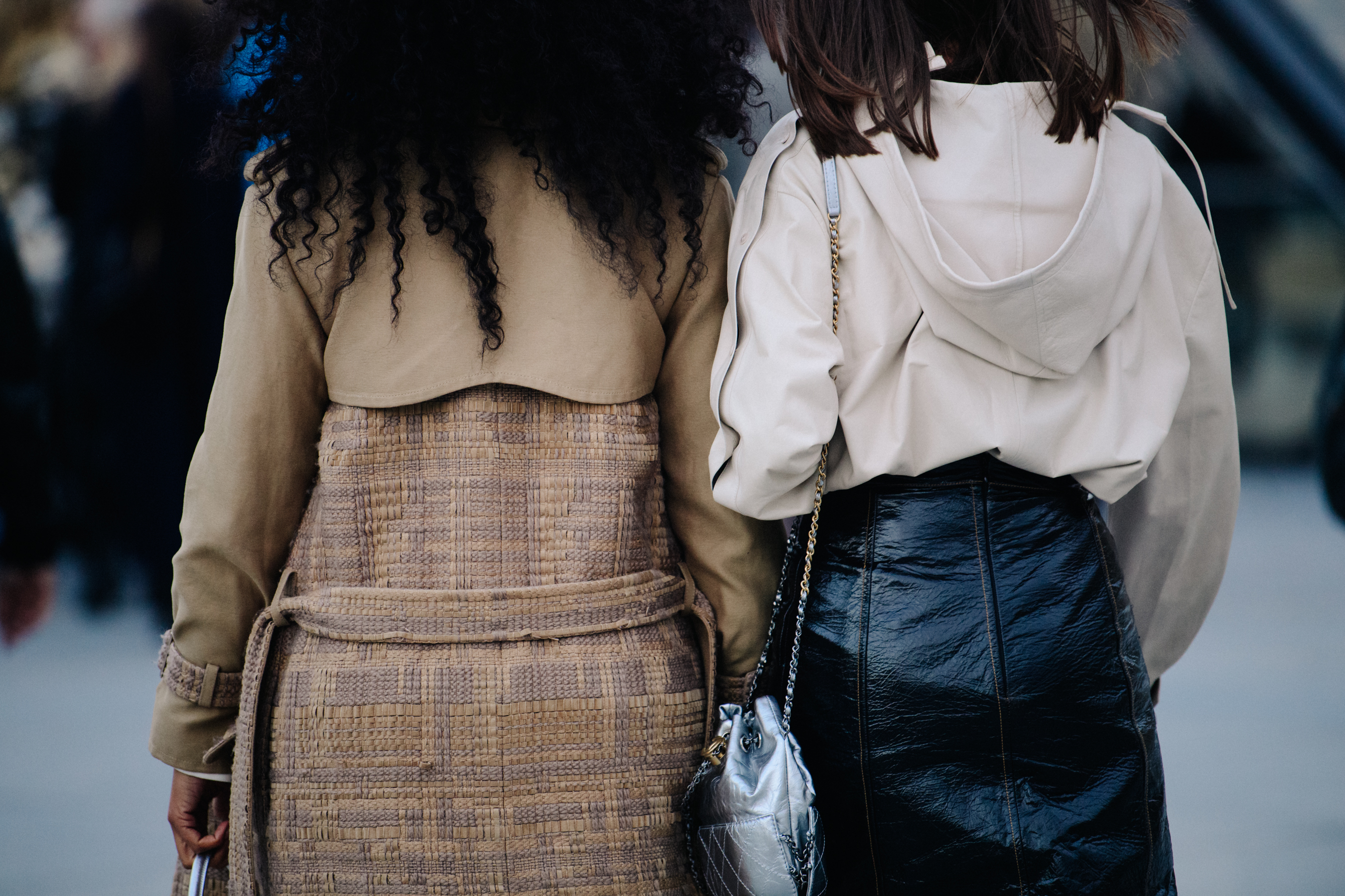 Two women wearing white and brown