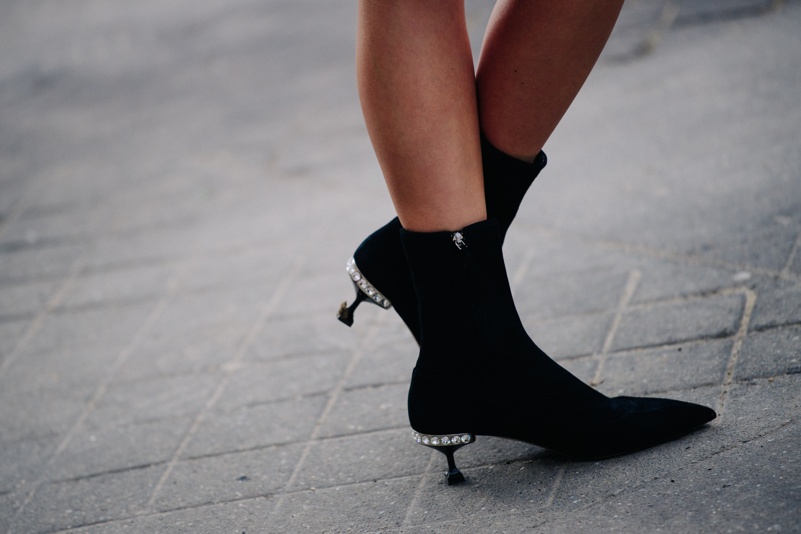 Woman wearing black and silver boots