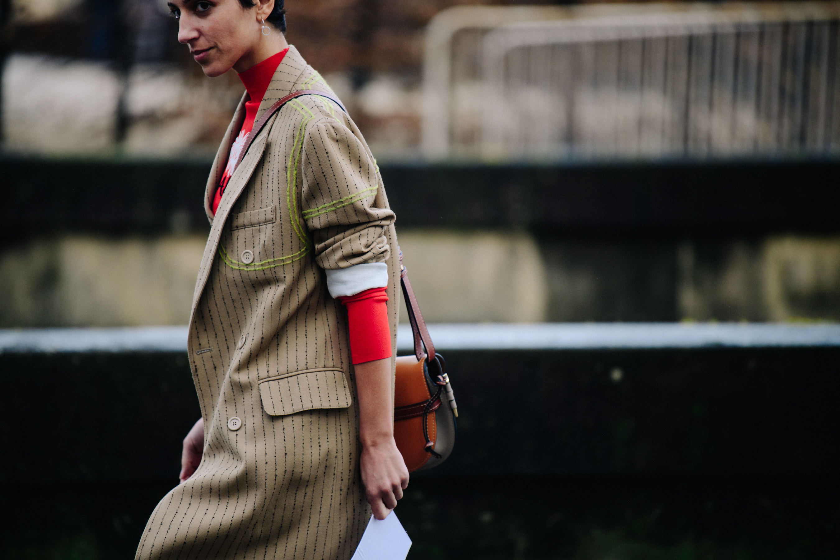Editor wearing striped tan coat