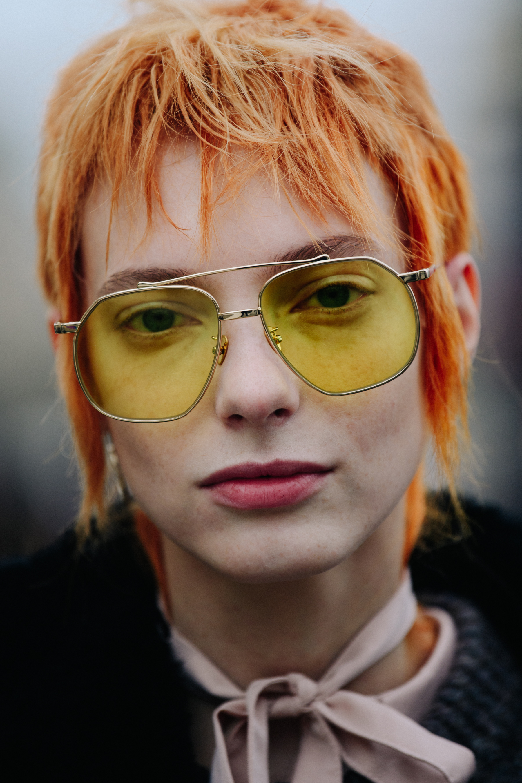 Portrait of model wearing yellow lens glasses