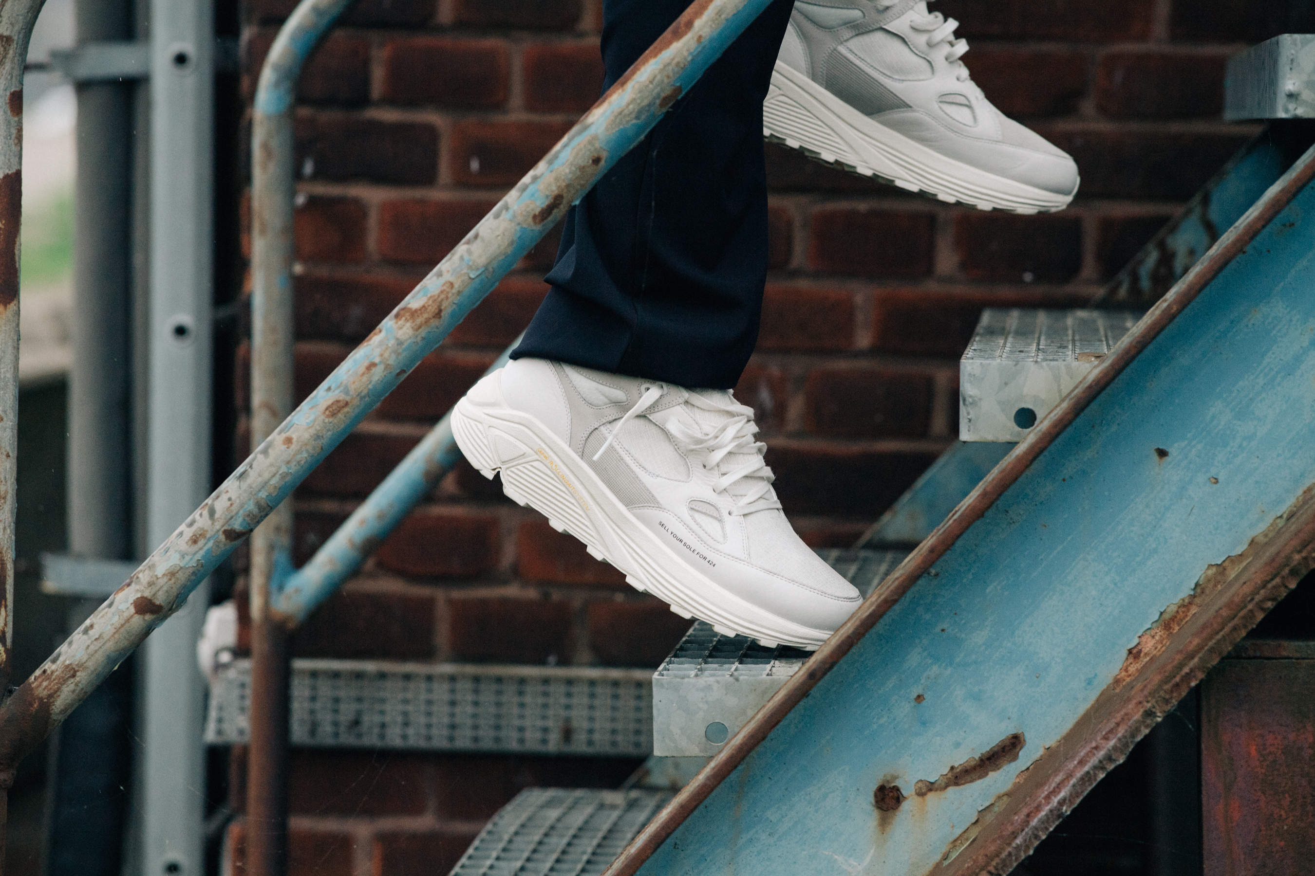 Male model wearing white runners