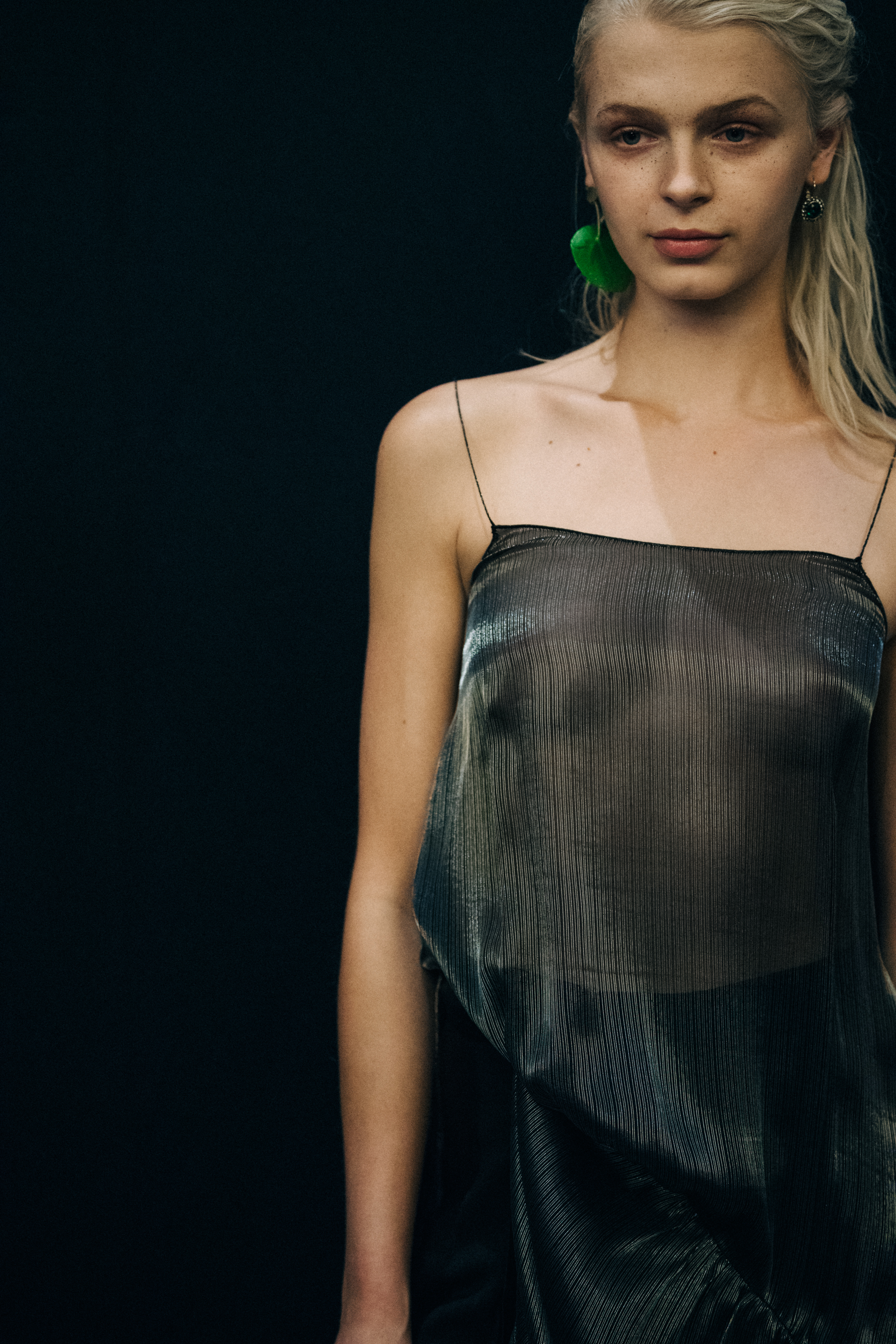 Model wearing see through top backstage