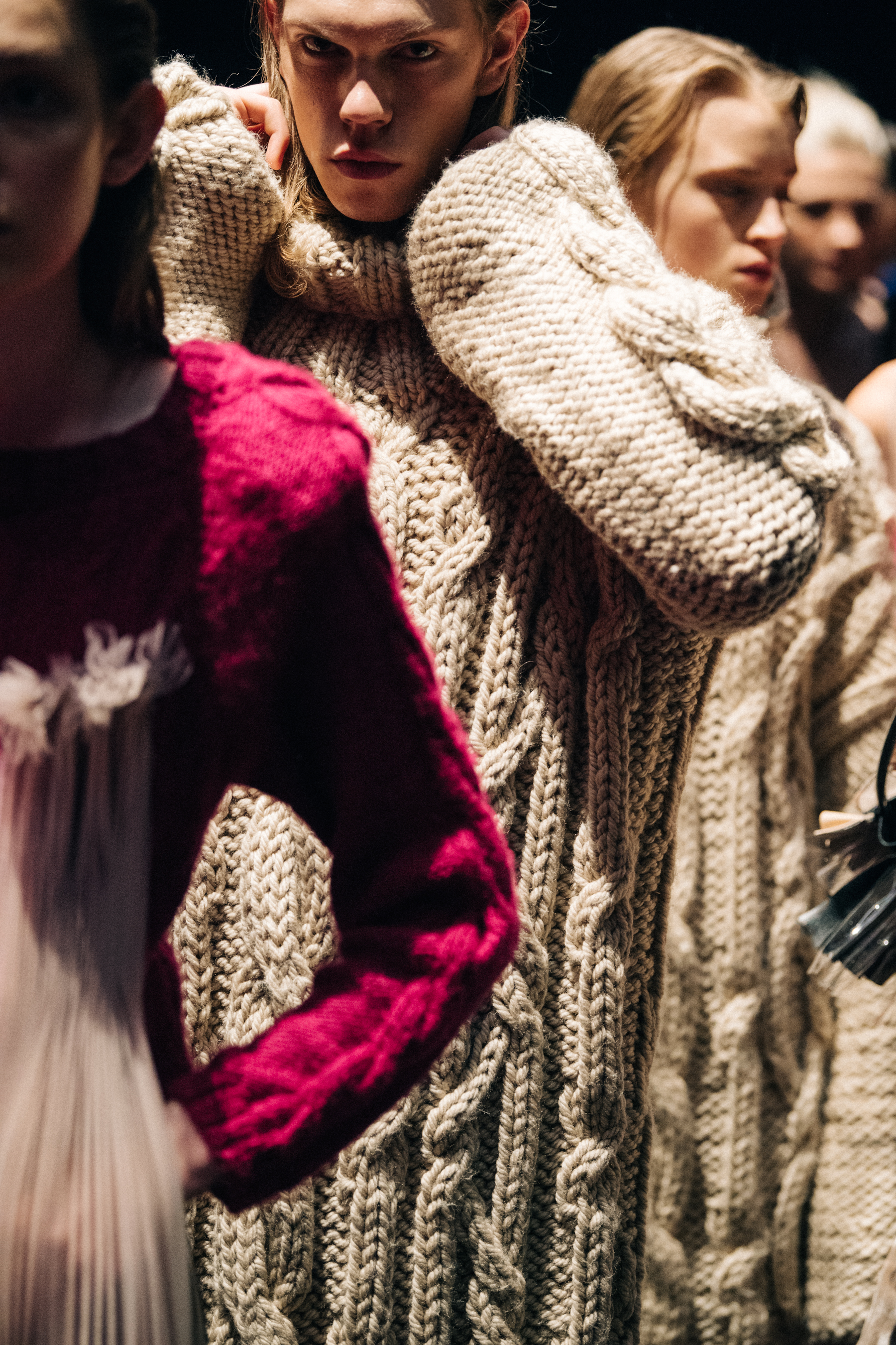 Model wearing pale wool knit backstage