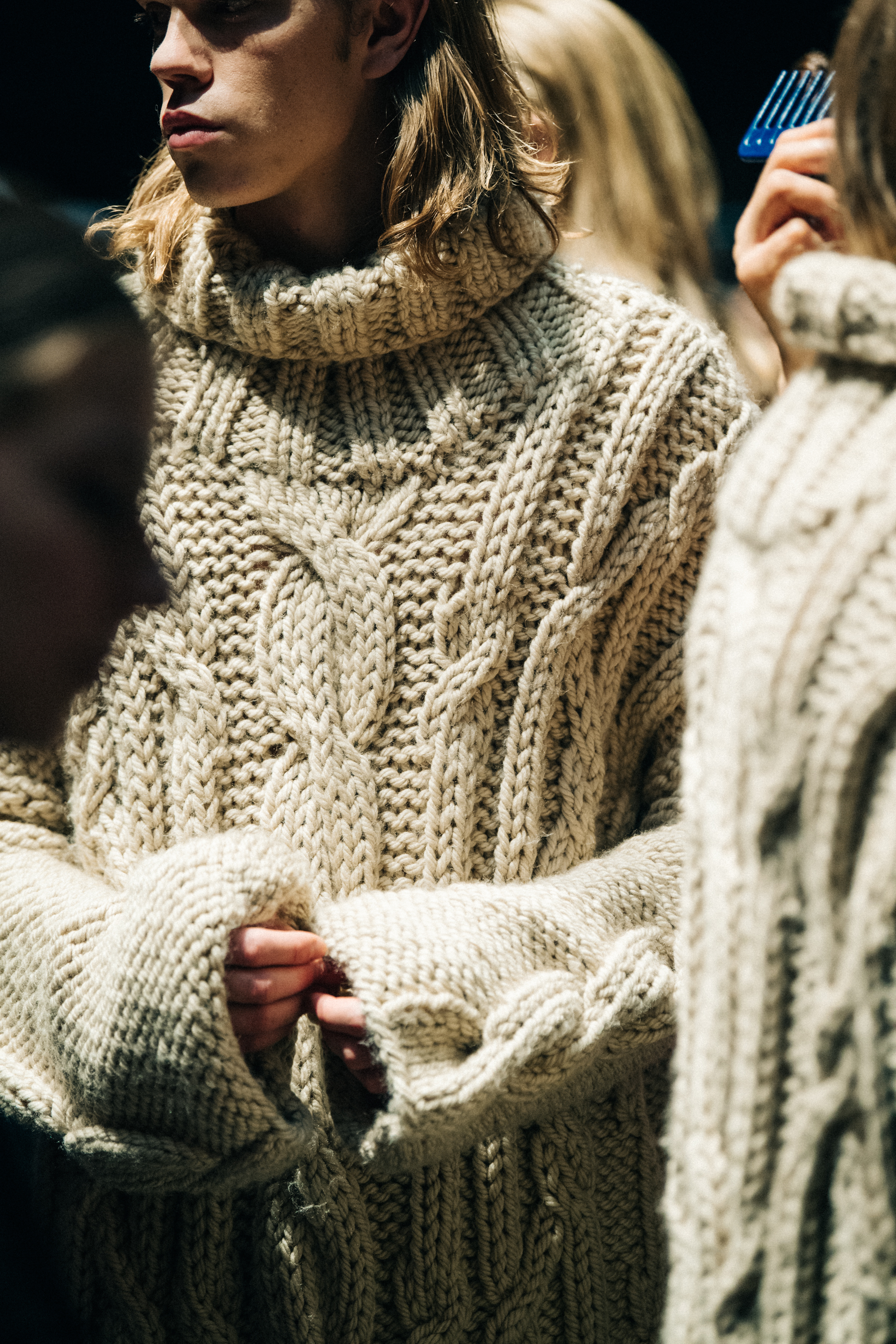 Model wearing pale wool knit backstage