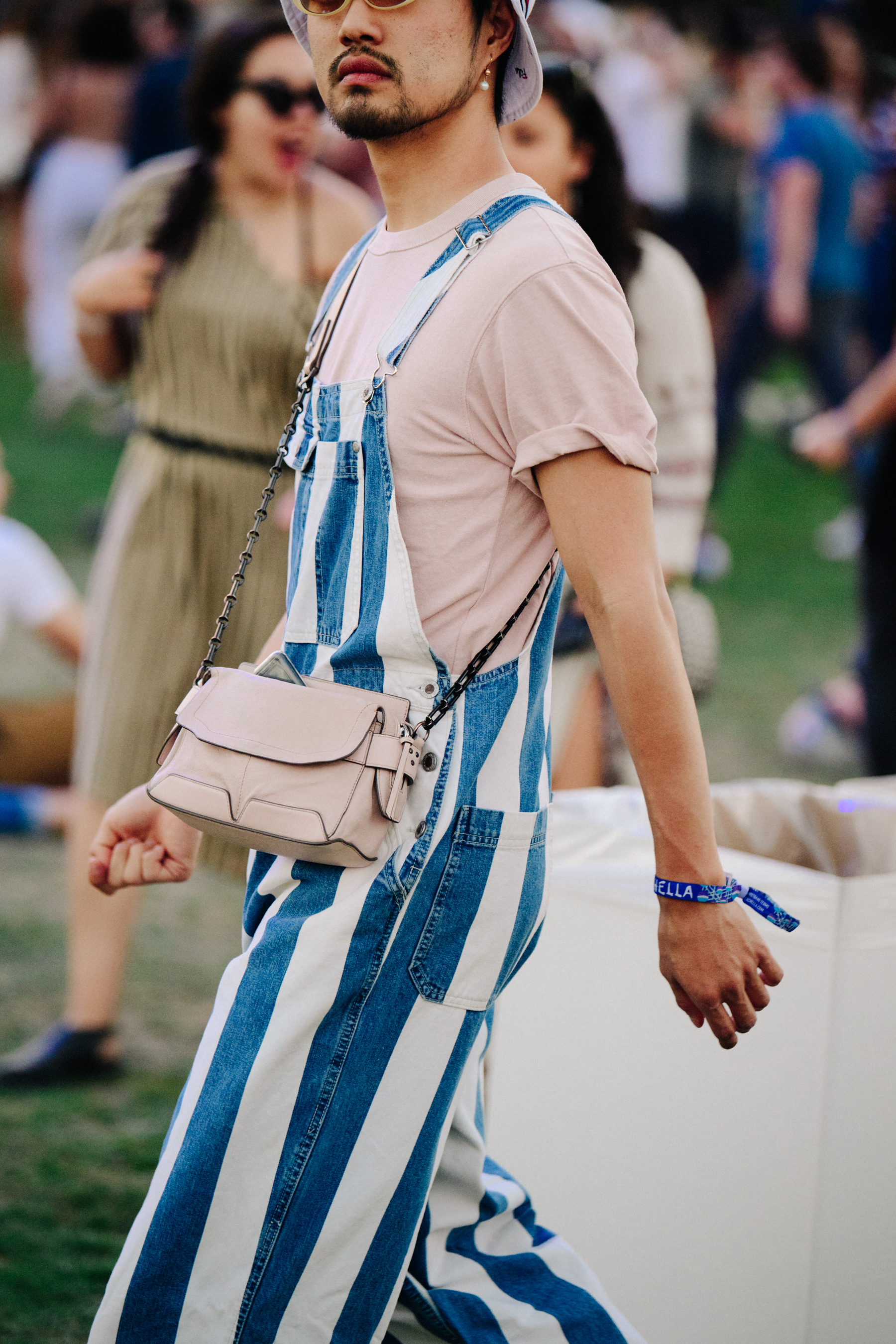 Asian man wearing striped dungarees