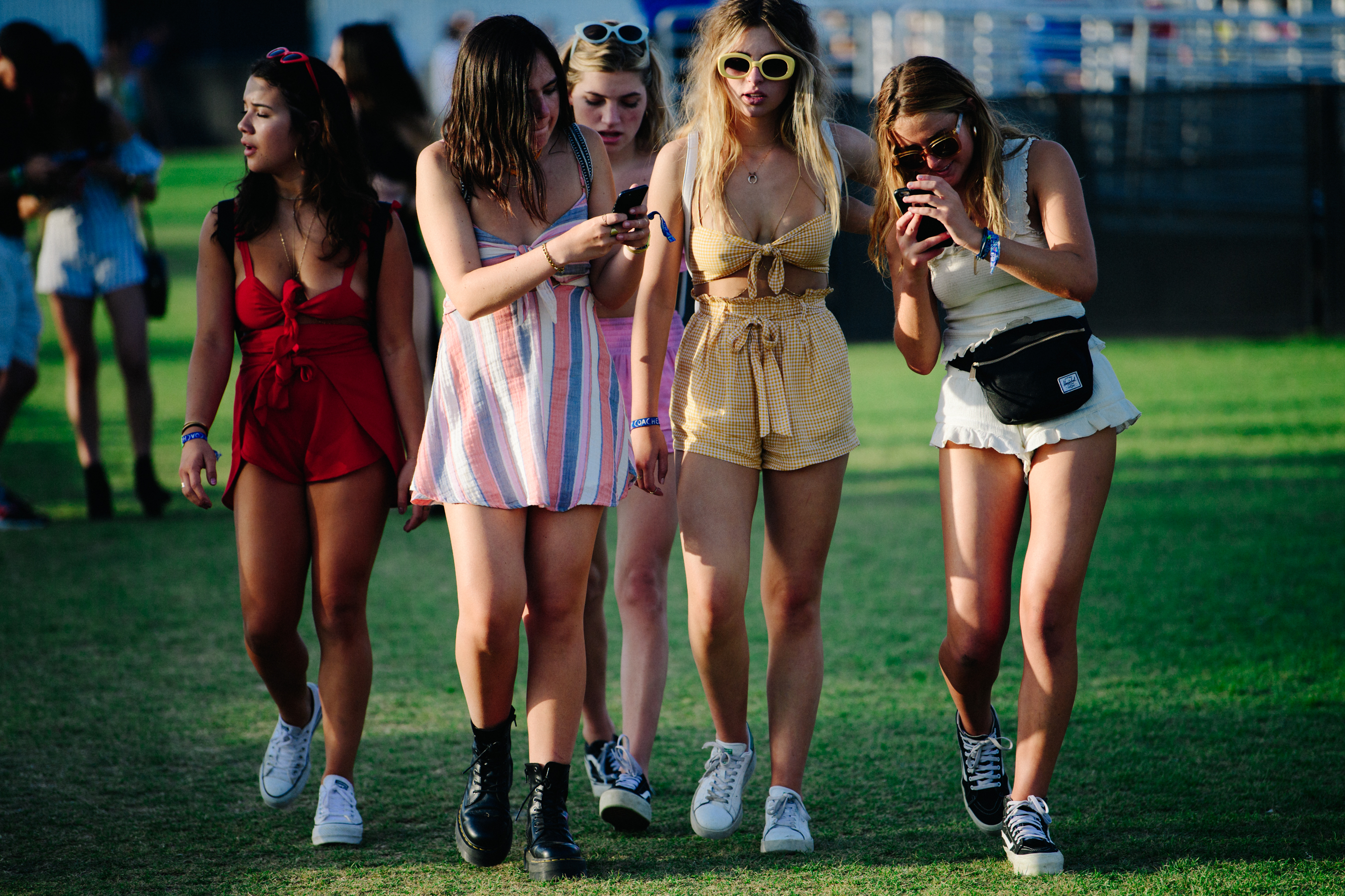 Five girls wearing shorts and skirts