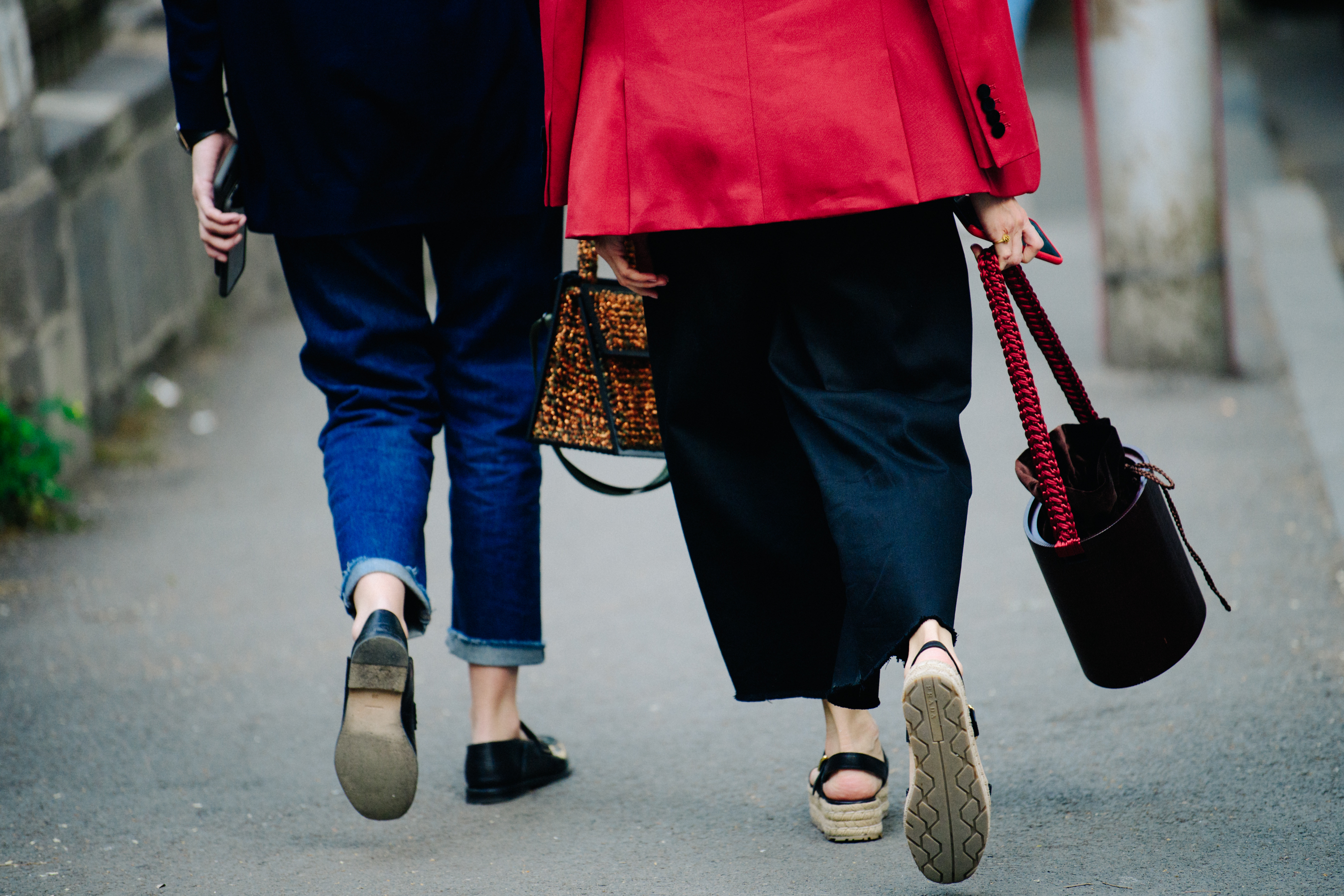 Two women carrying handbags