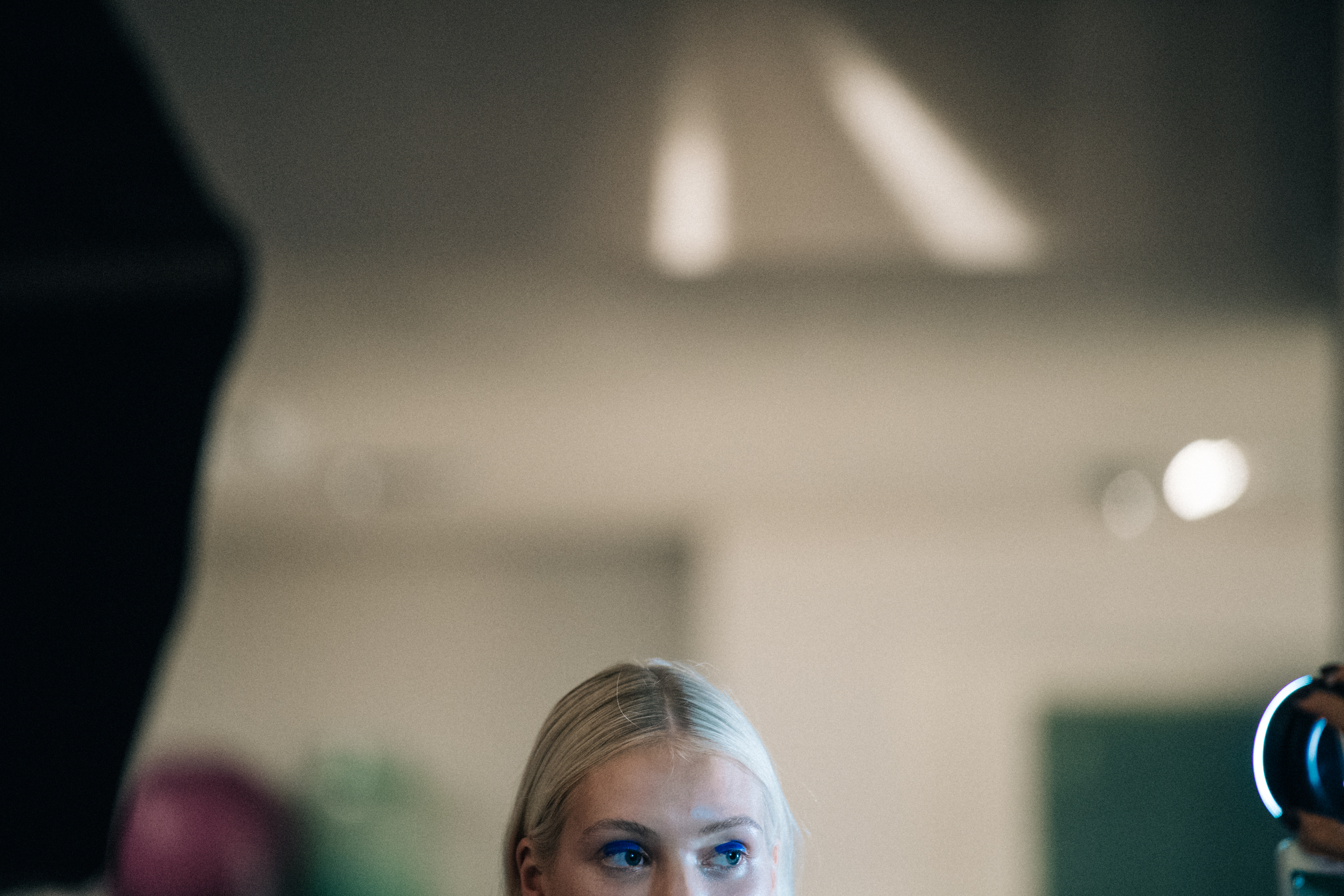 Model with long blonde hair backstage