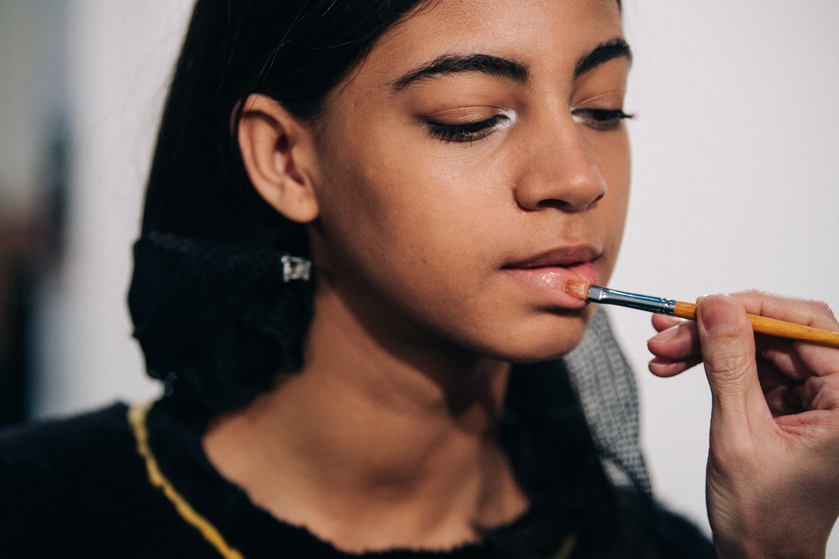 Model having makeup applied backstage