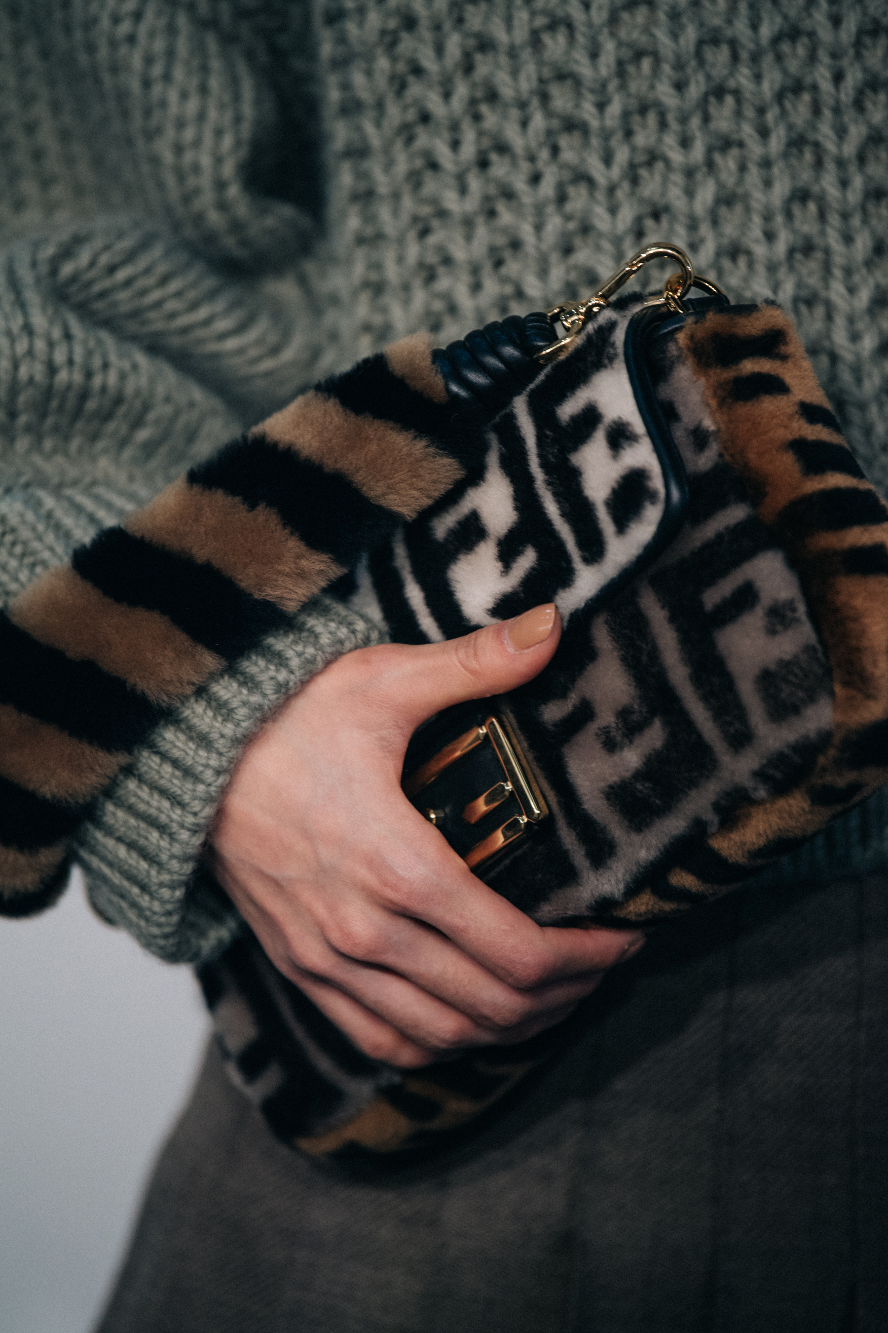Model holding Fendi bag backstage