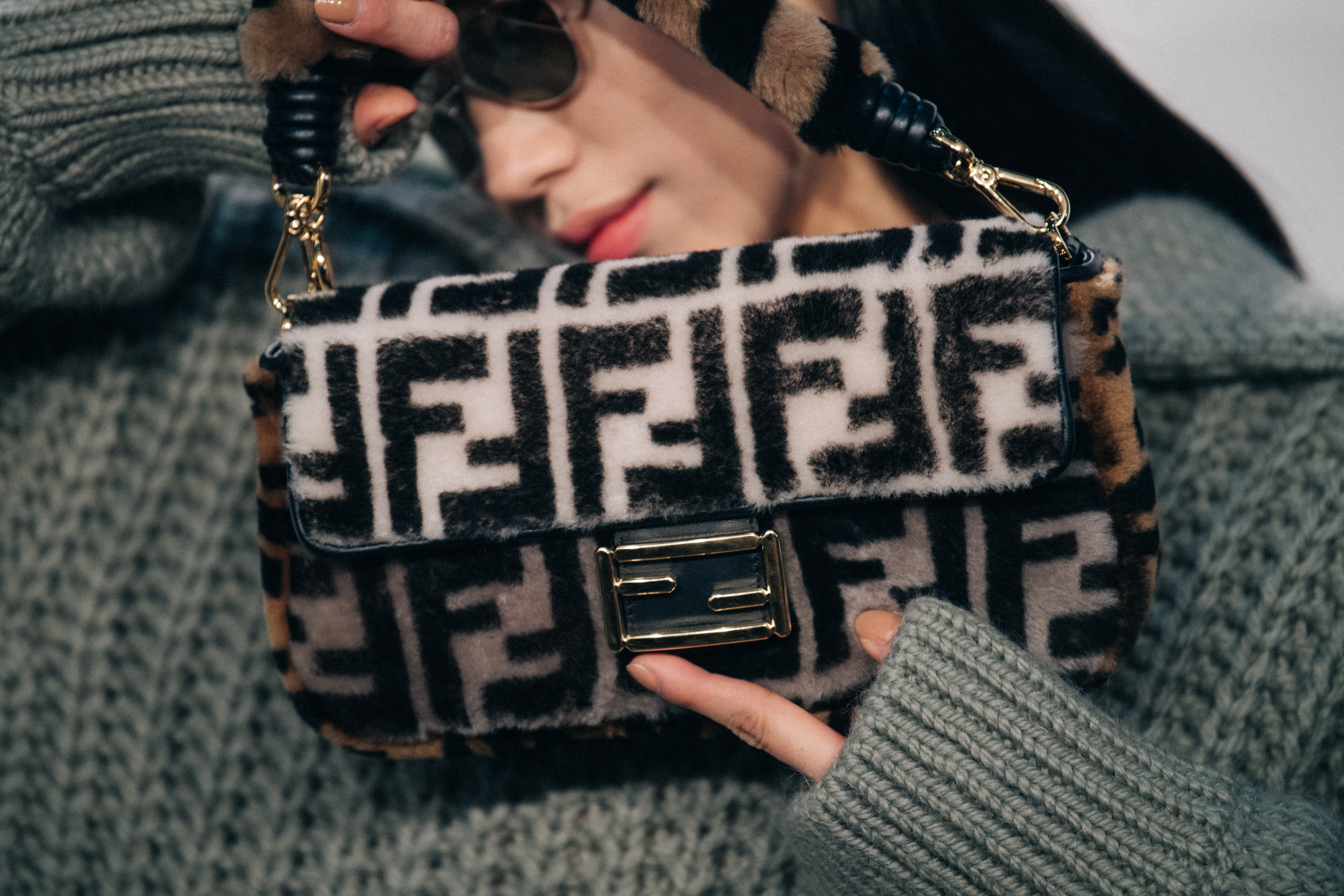 Model holding Fendi bag backstage