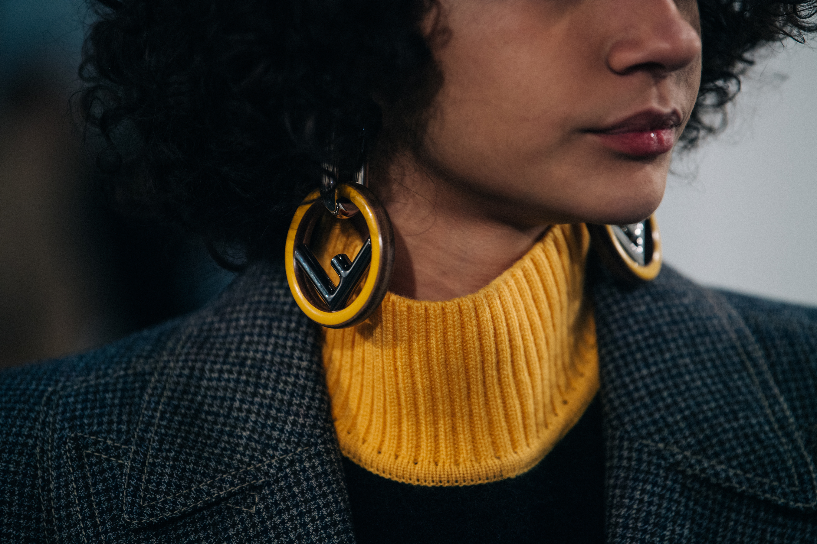 Model with curly hair wearing Fendi sweater