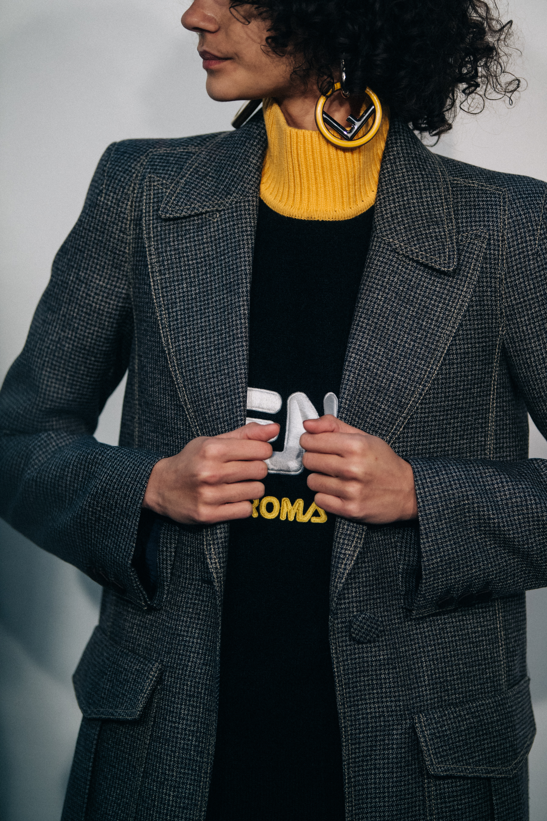 Model with curly hair wearing Fendi sweater