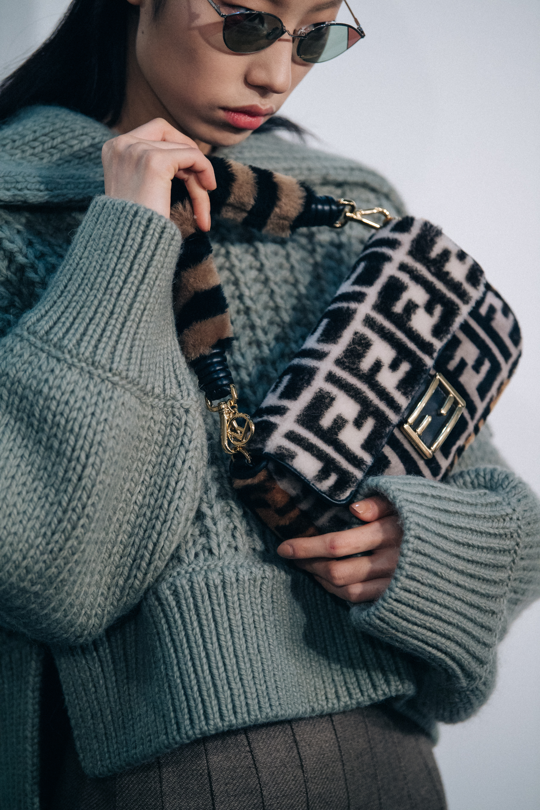 Model holding Fendi bag backstage