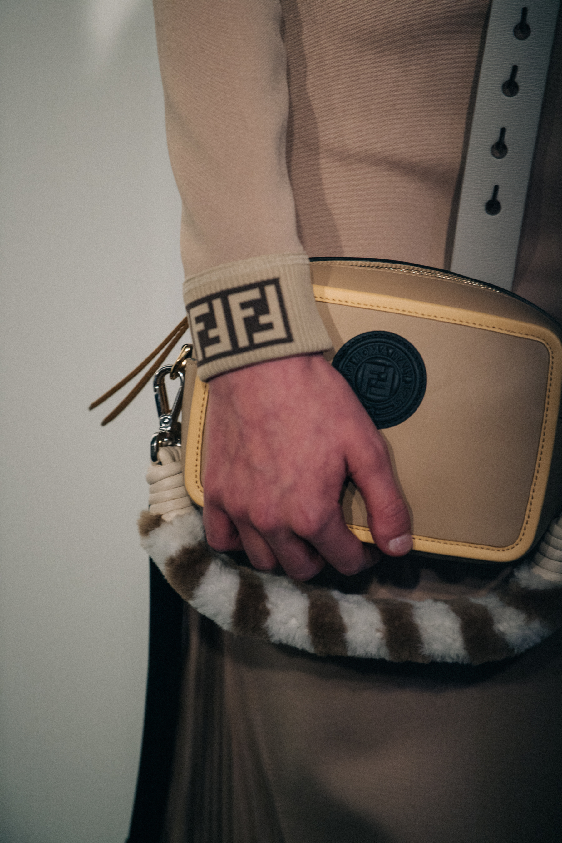 Model holding Fendi bag backstage