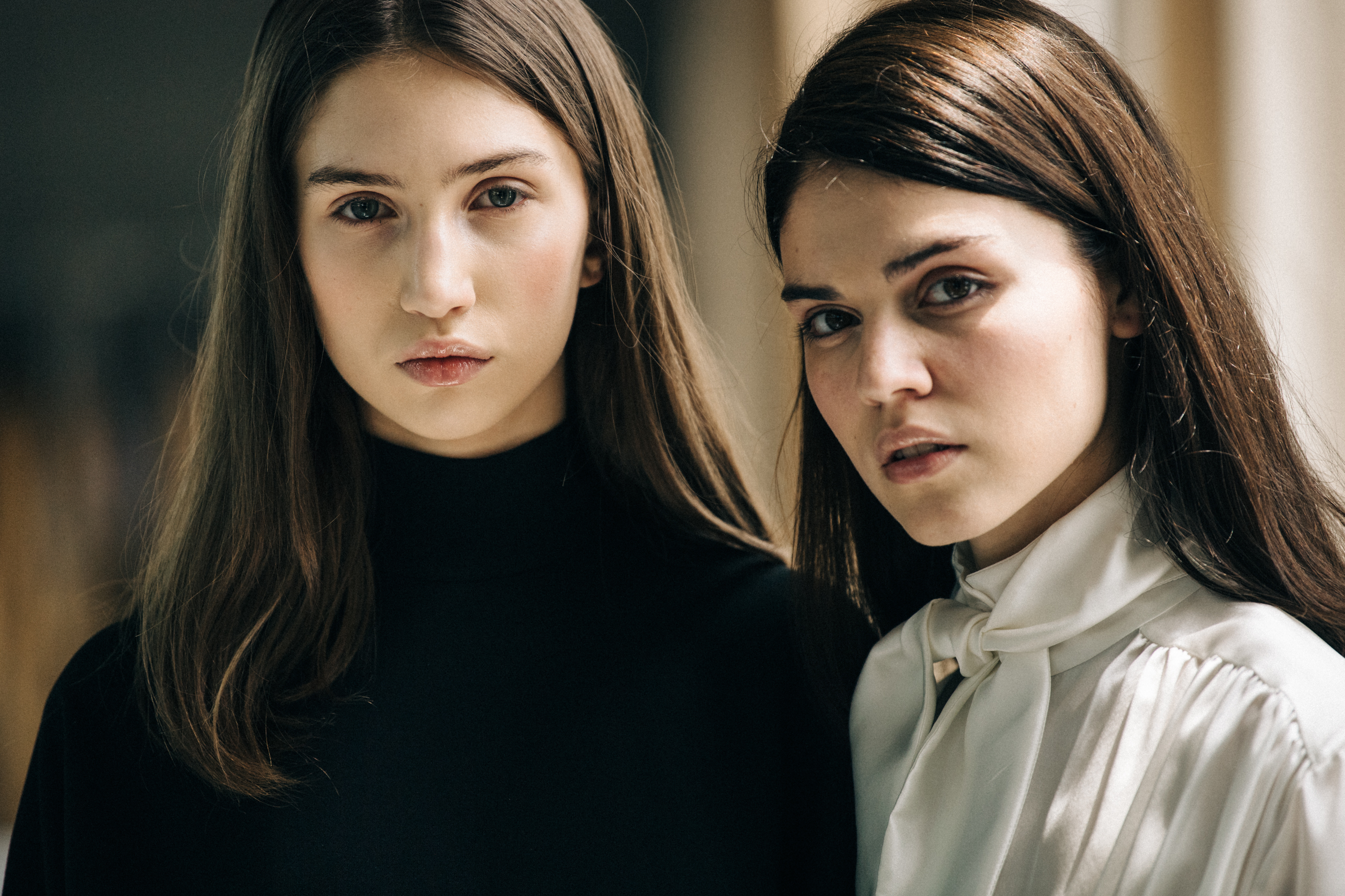 Two models with brown hair backstage