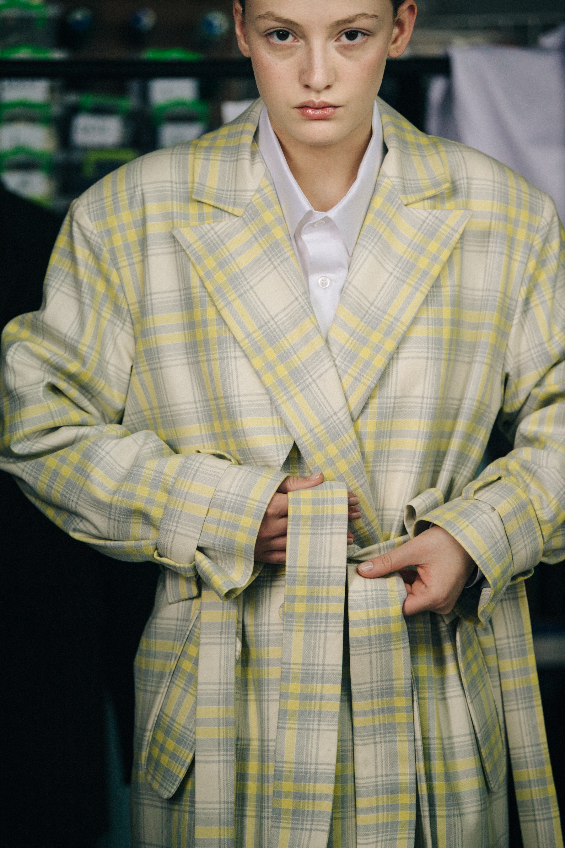 Model wearing yellow check coat backstage
