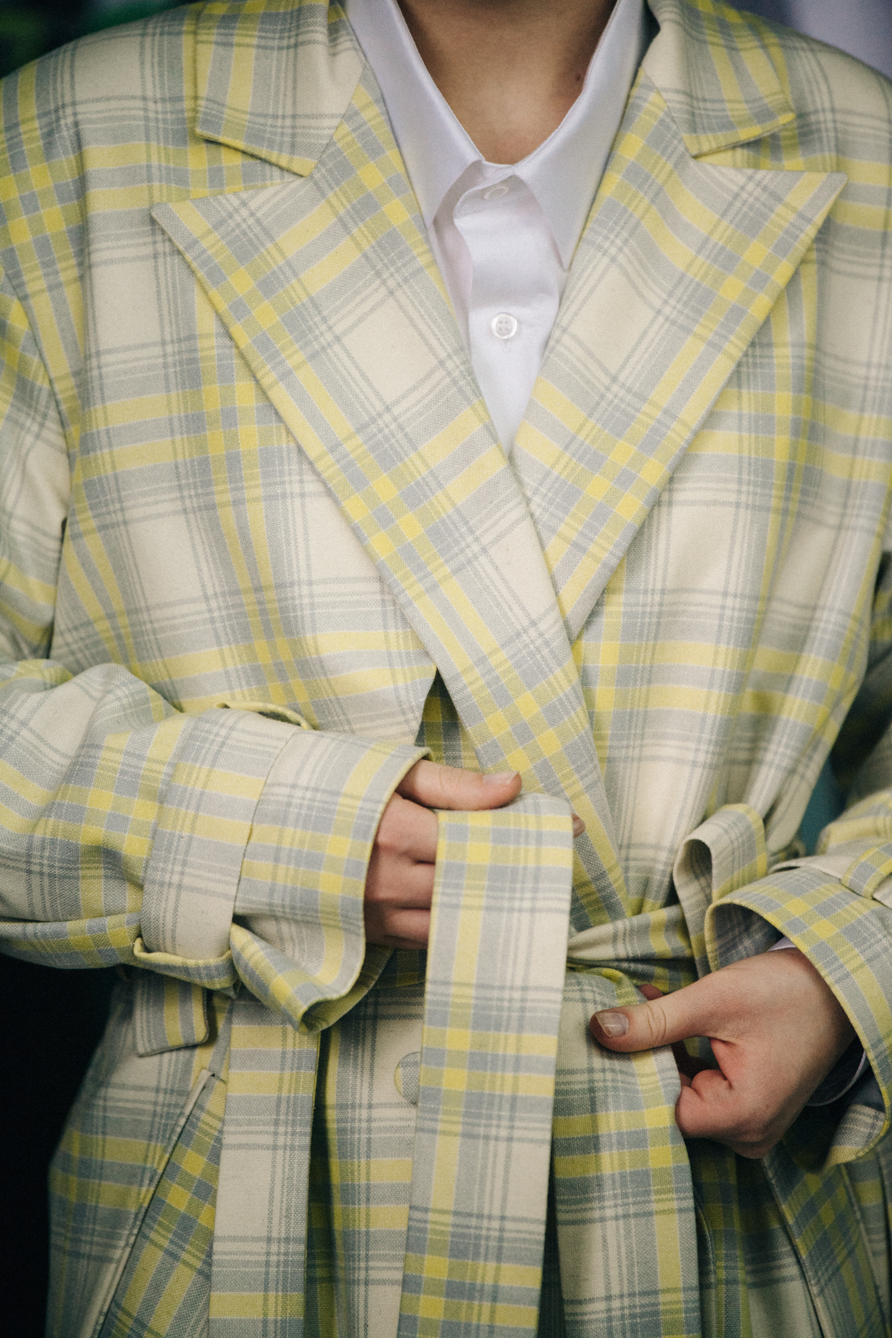 Model wearing yellow check coat backstage
