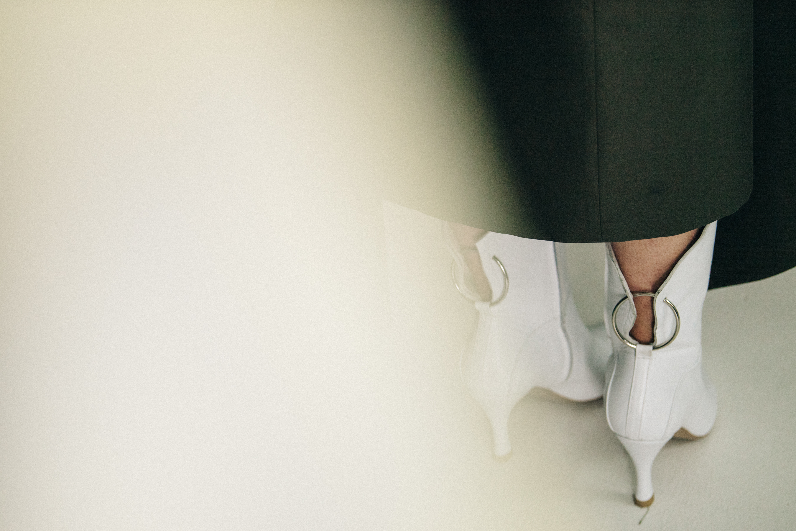 Model wearing white heels backstage