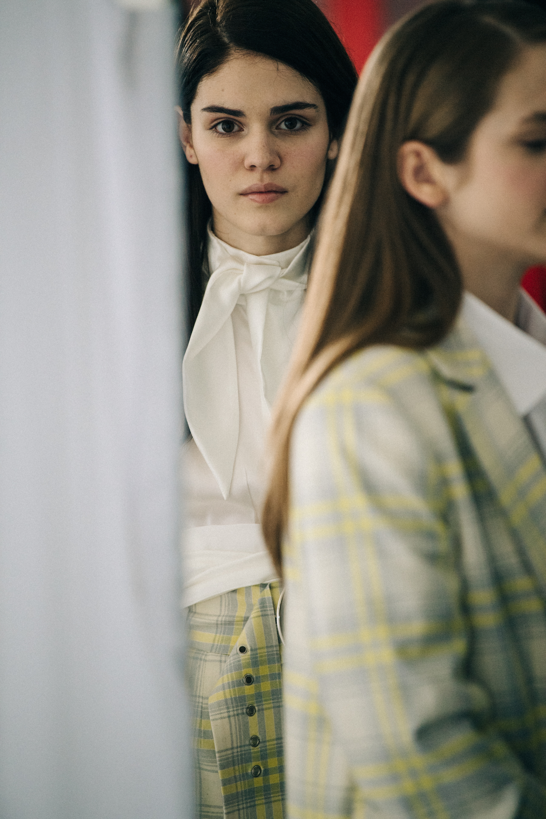 Model wearing white shirt backstage