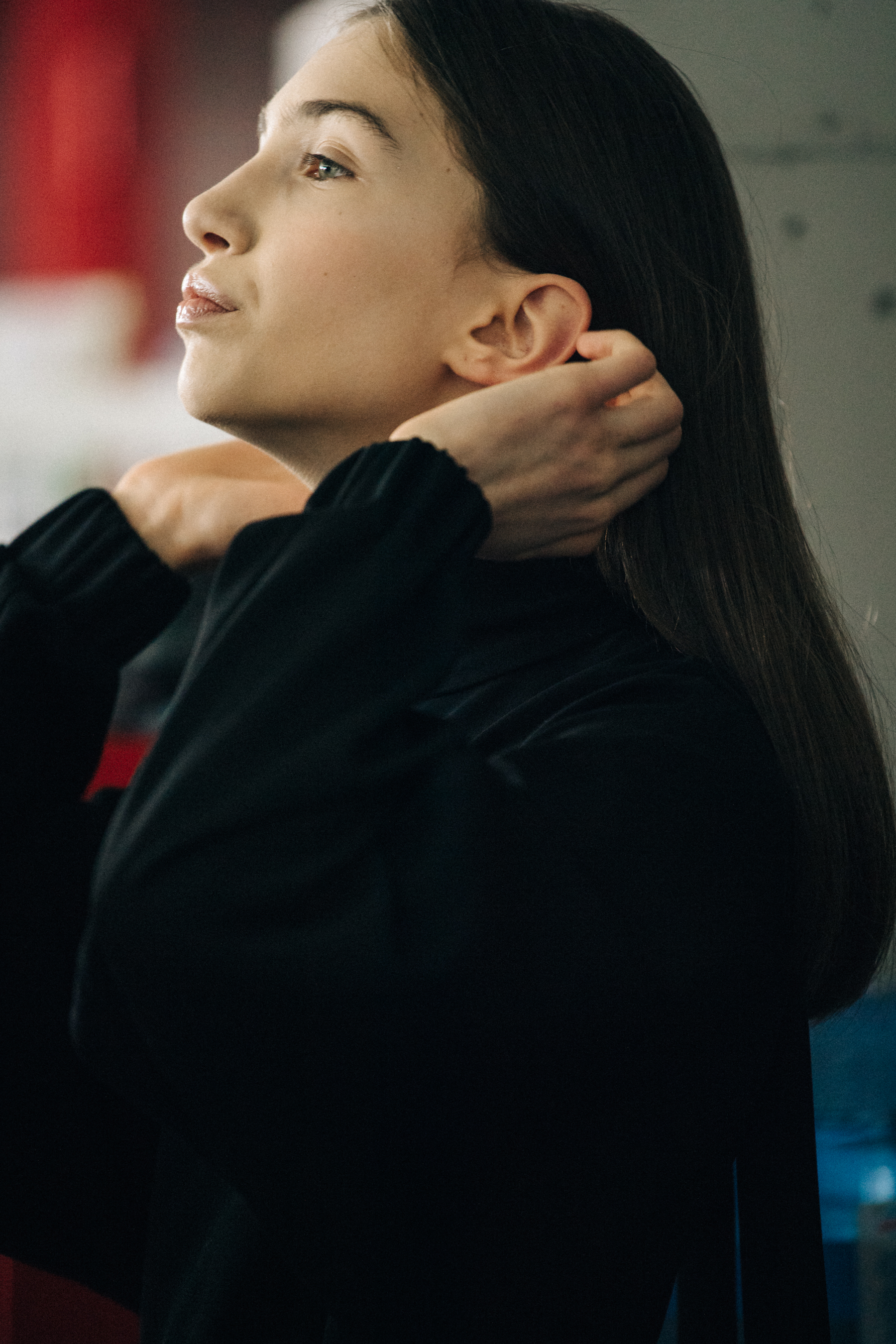 Model wearing black dress backstage