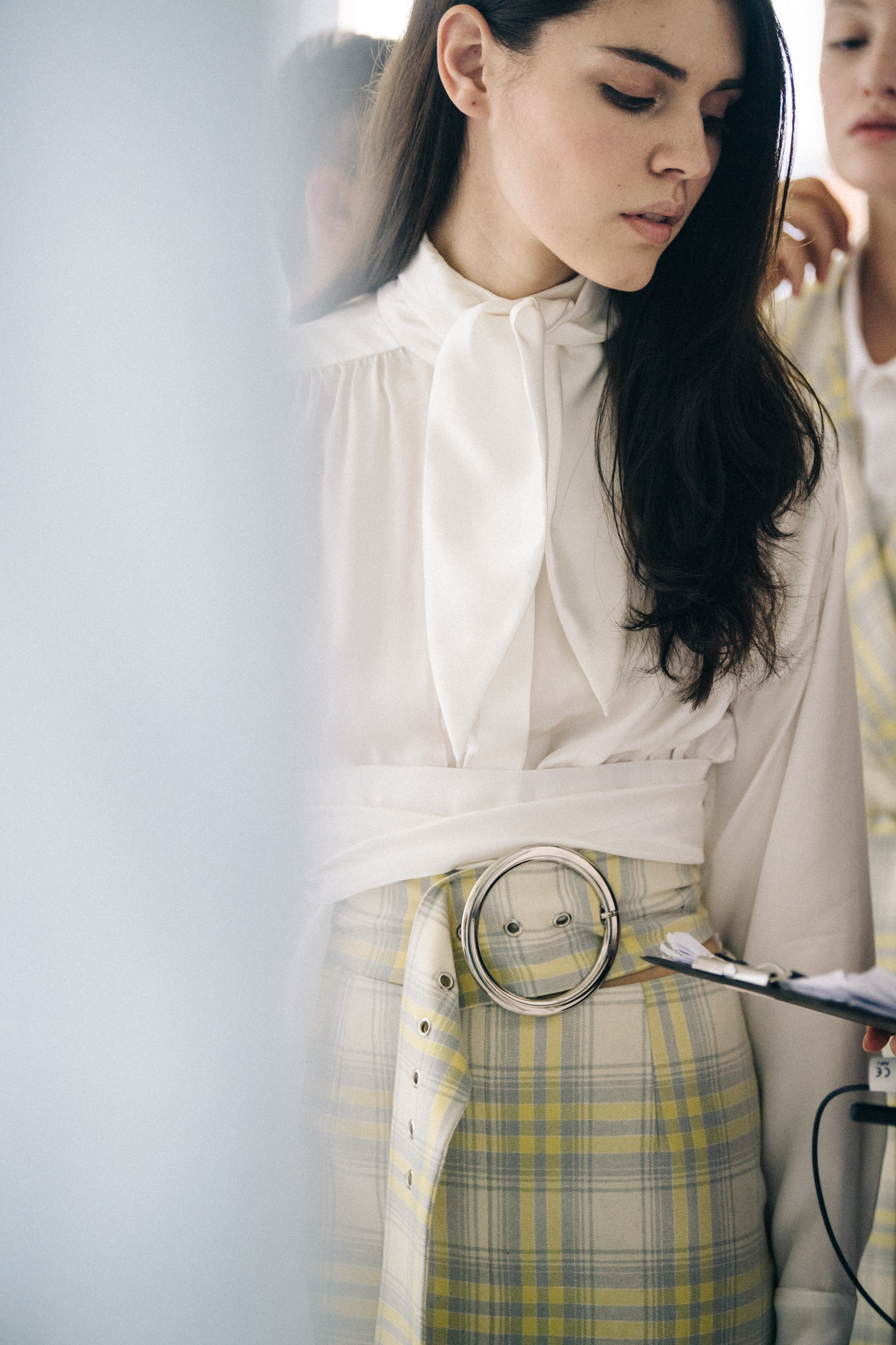 Model wearing white shirt backstage