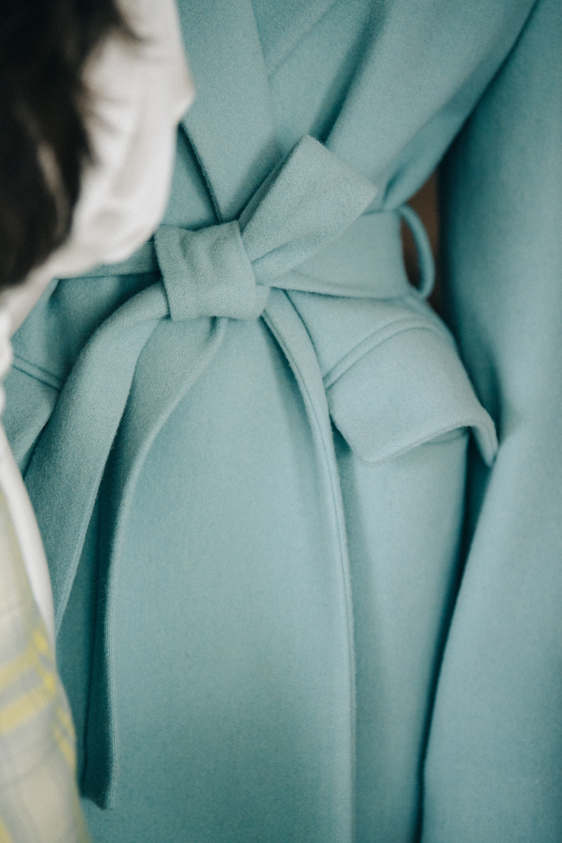 Model wearing blue coat backstage