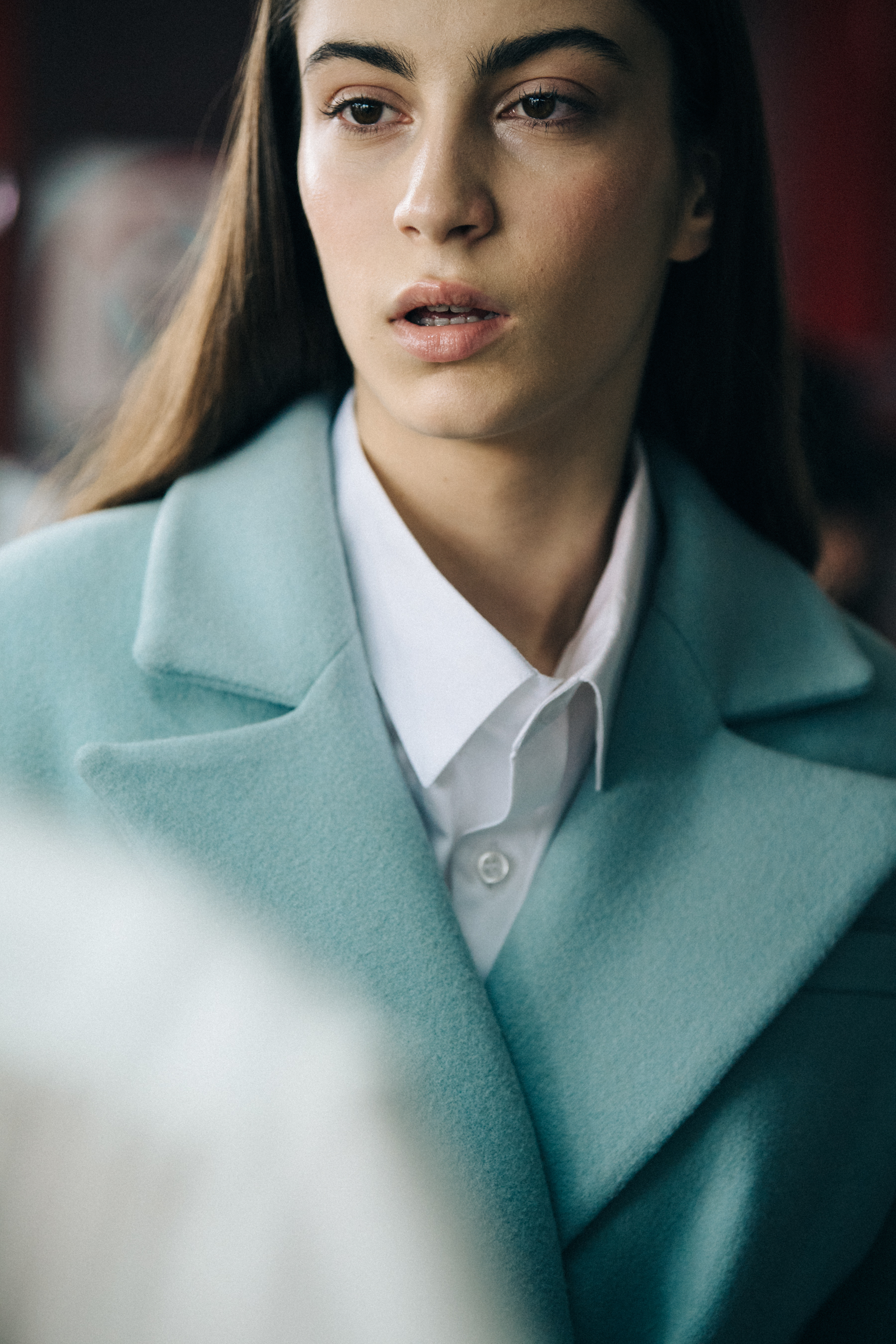 Model wearing blue coat backstage