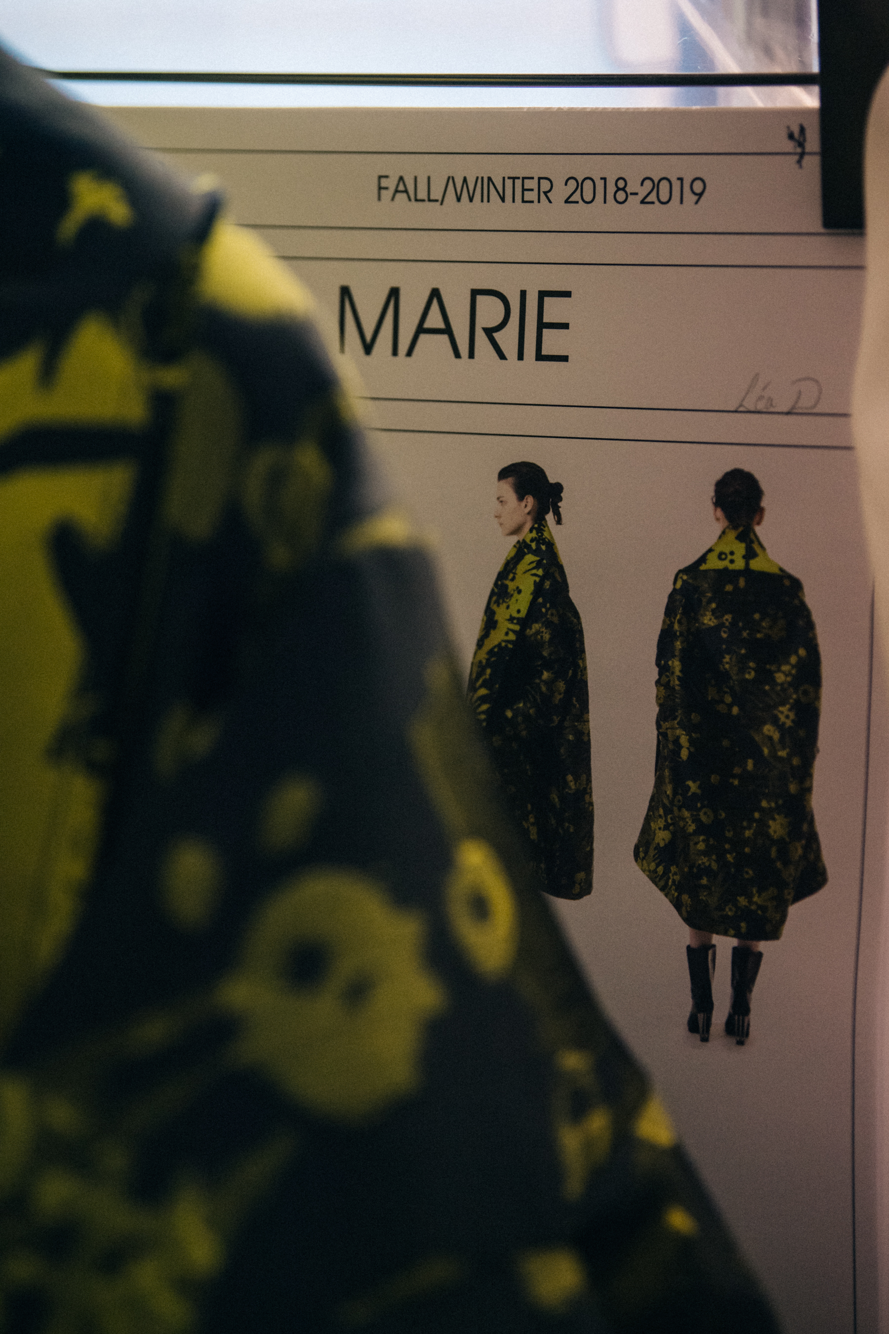 Model polaroids and outfit cards backstage