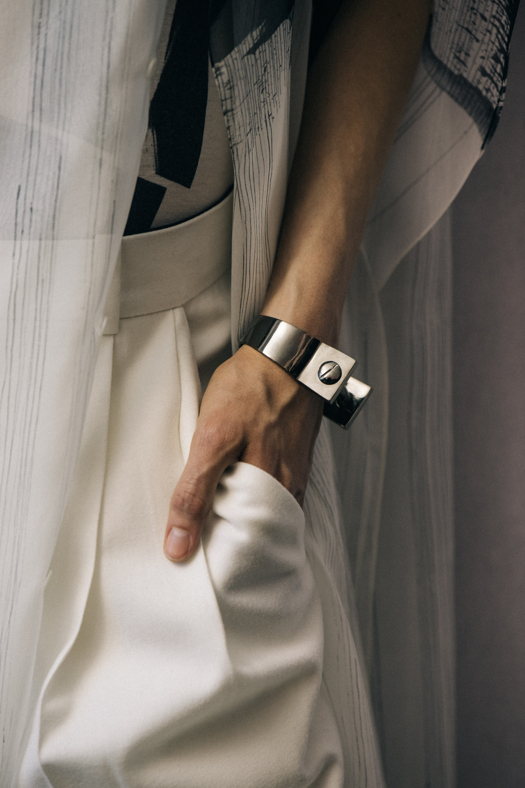 Model wearing metal bracelet