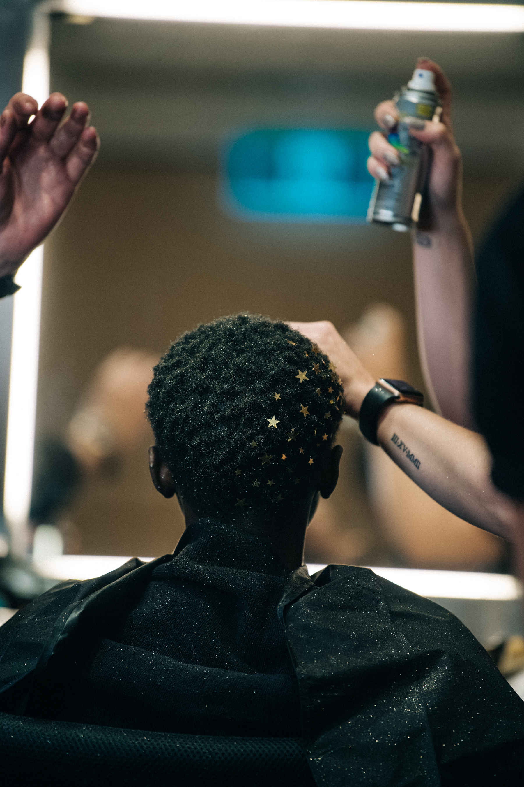 Model having makeup applied backstage