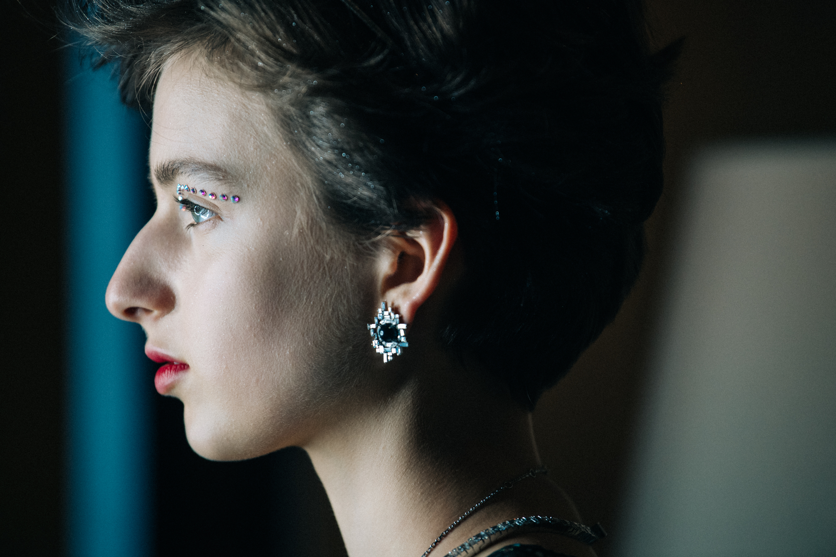 Model wearing large silver earrings