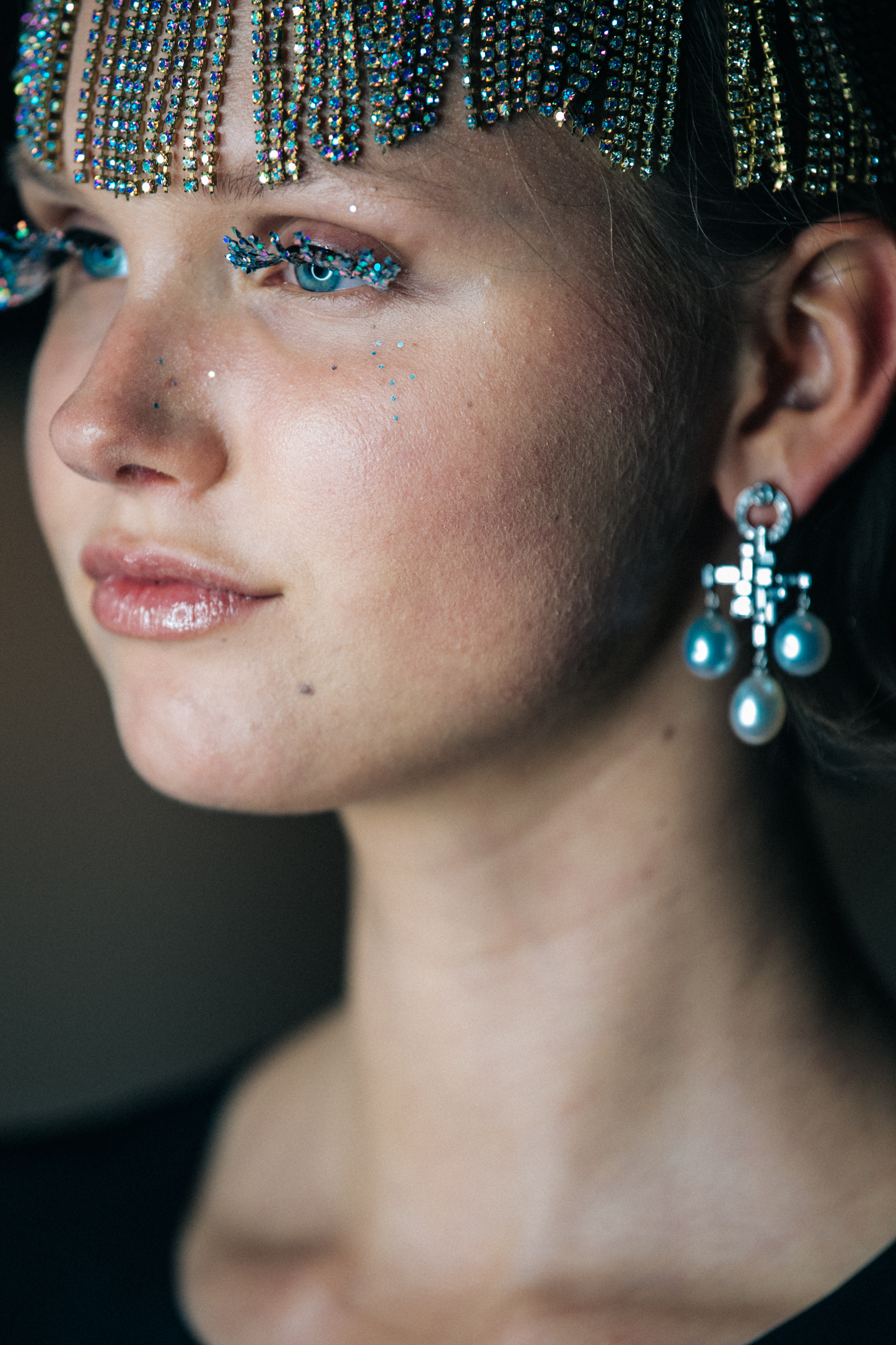 Model wearing large silver earrings