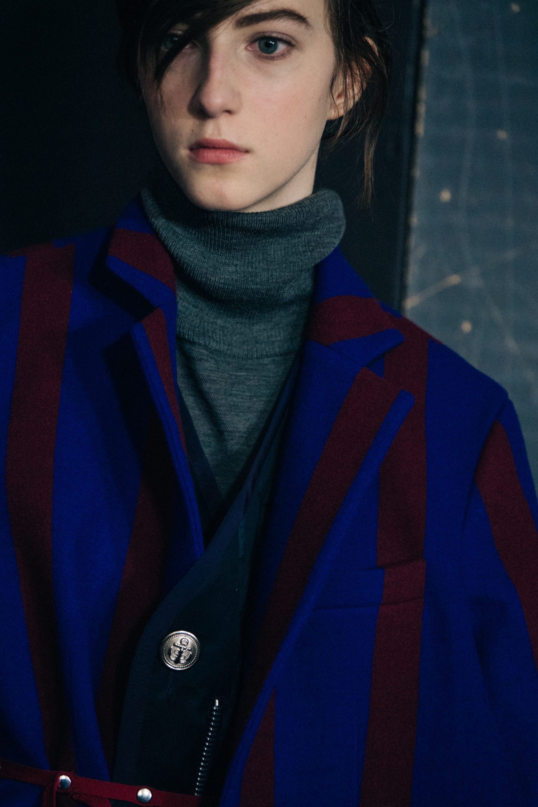Model wearing blue and red Sacai outfit