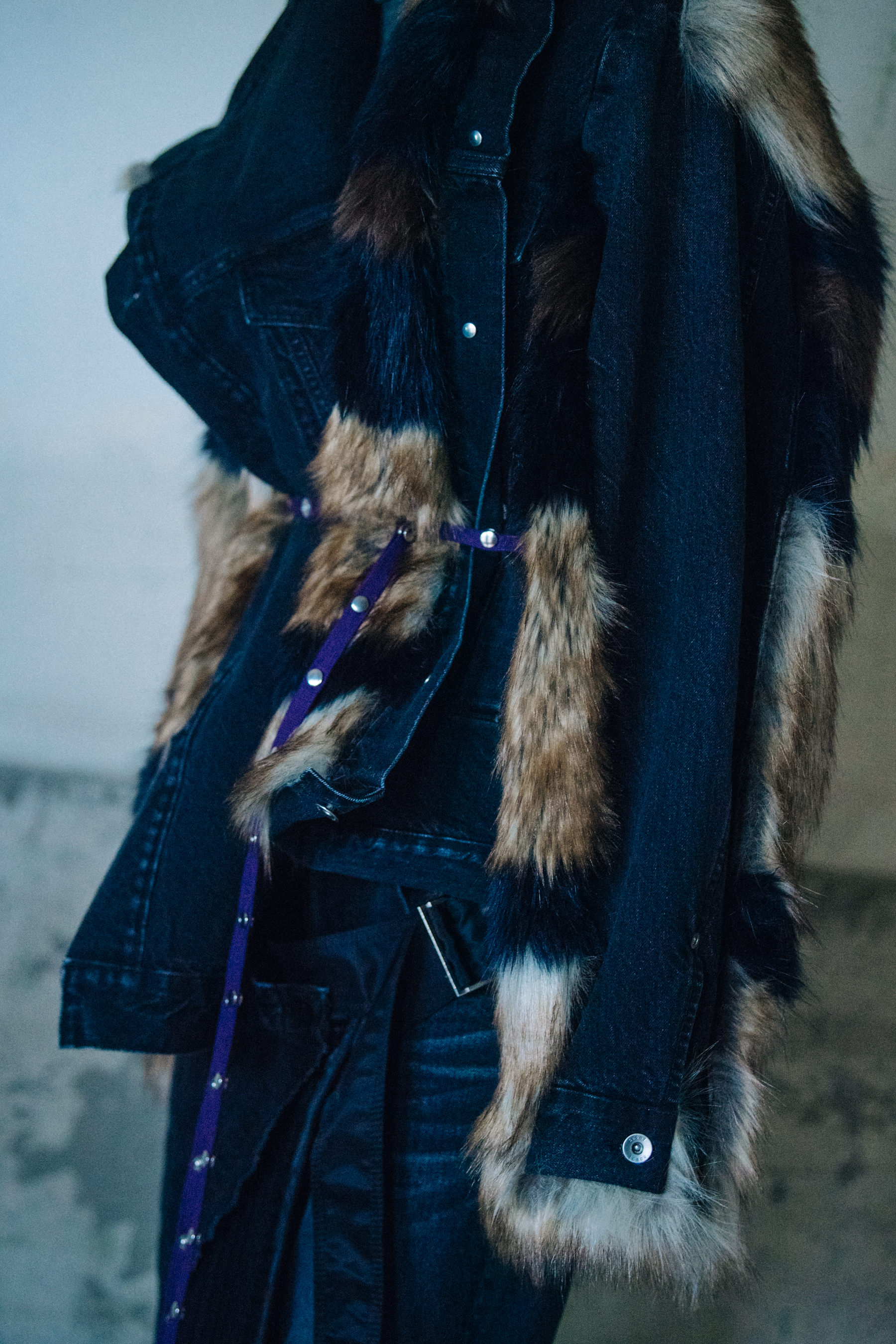 Model wearing fur and denim look at Sacai