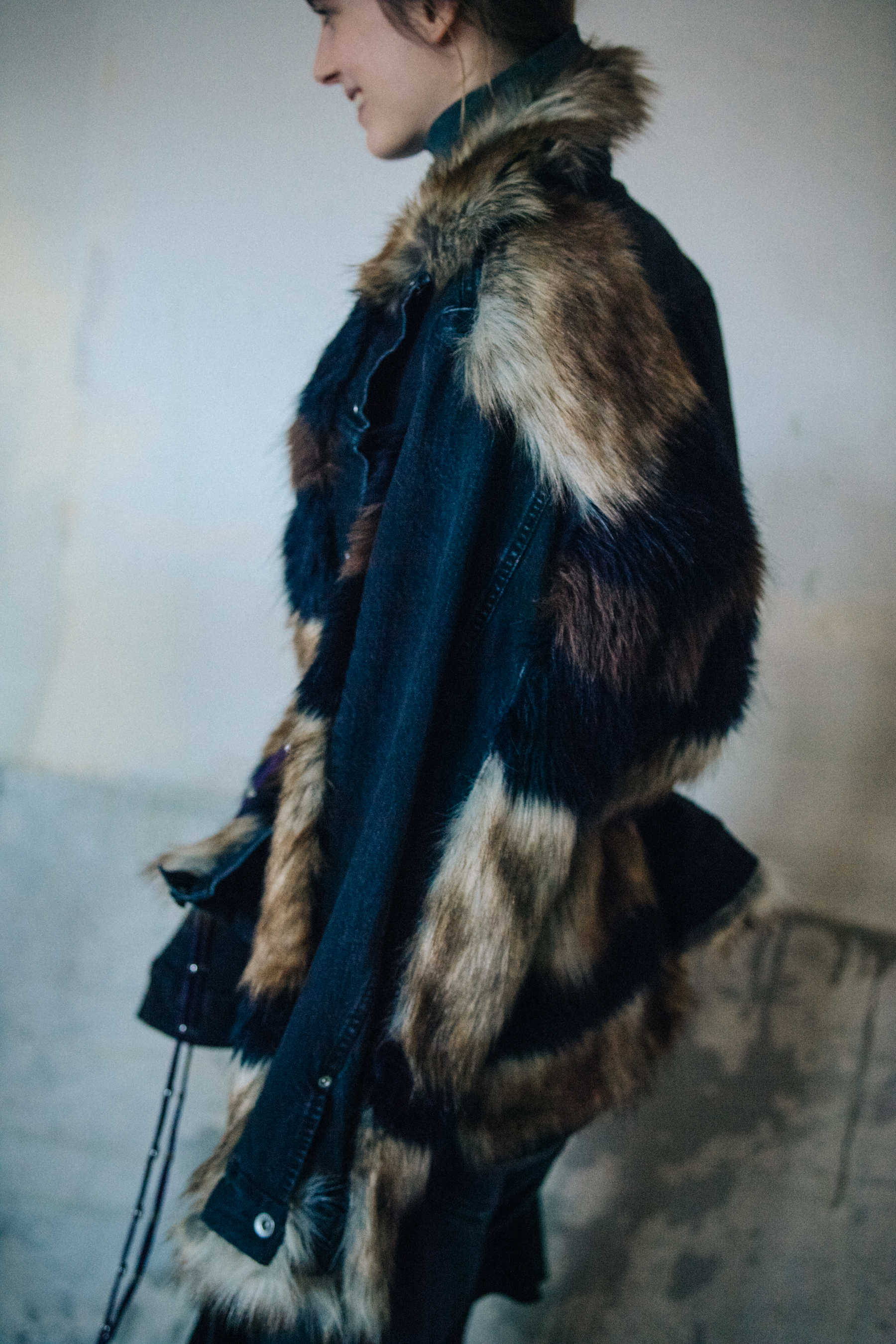 Model wearing fur and denim look at Sacai