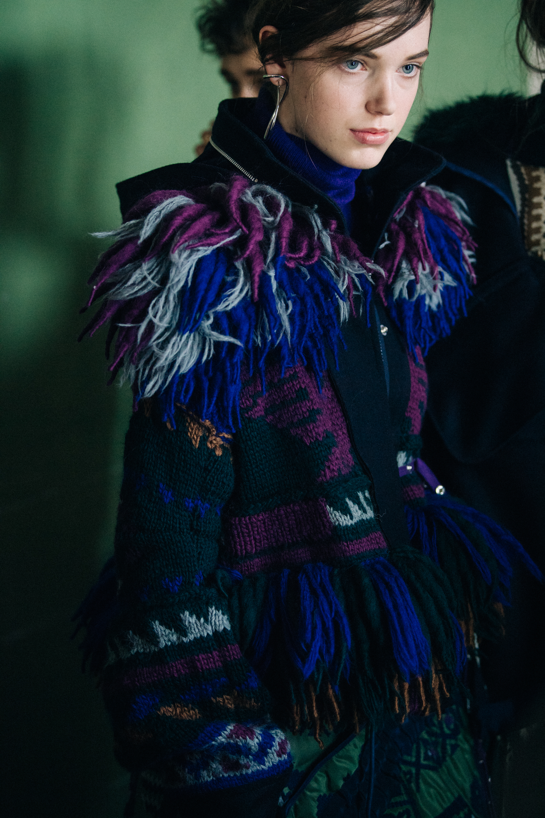 Model wearing purple and blue outfit at Sacai