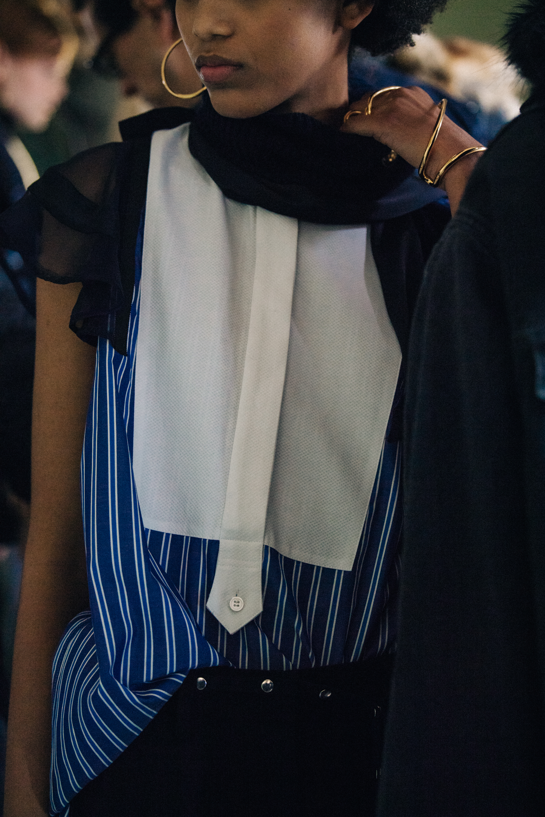 Model wearing white and blue striped shirt