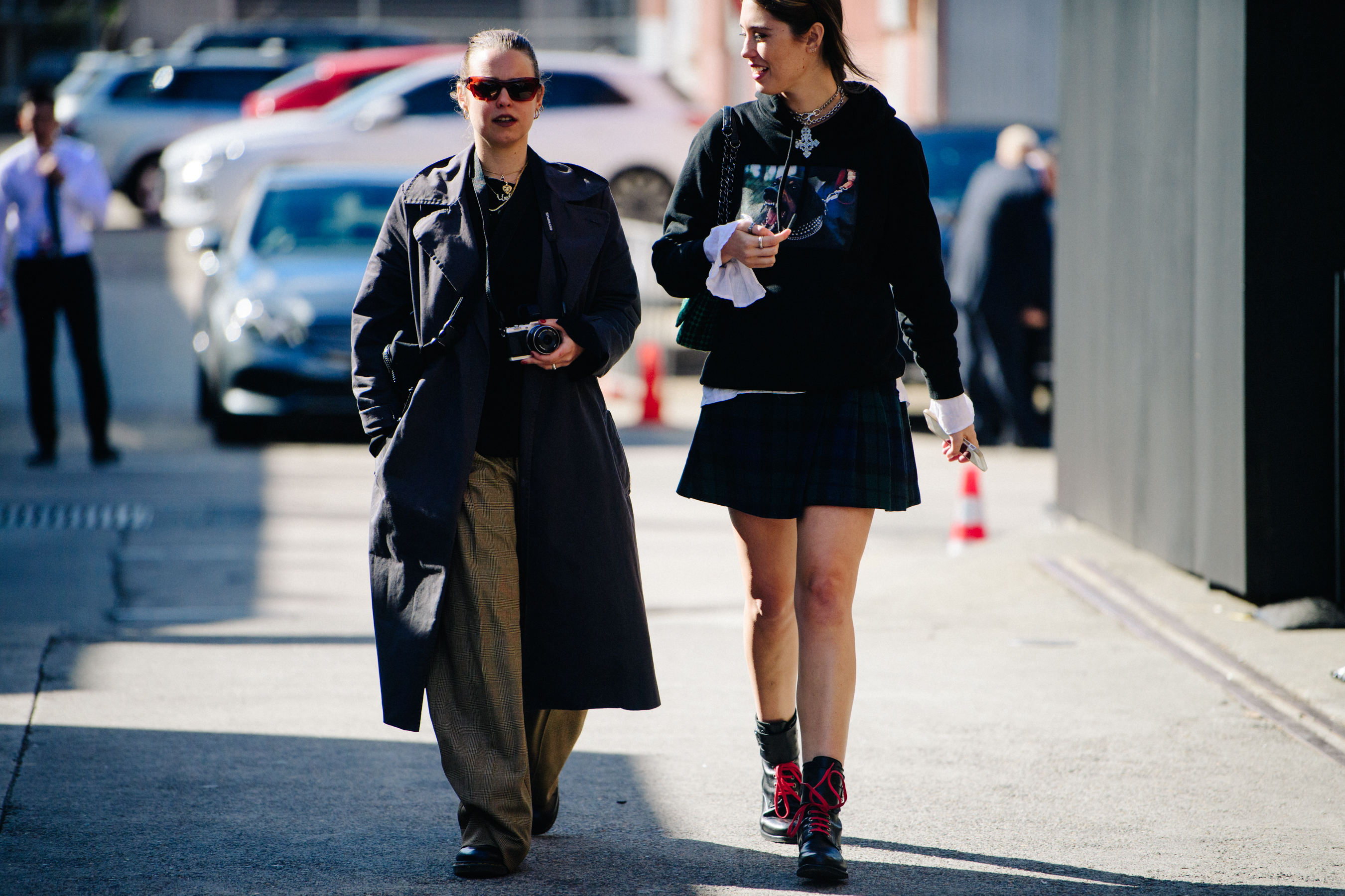 Two women wearing dark outfits