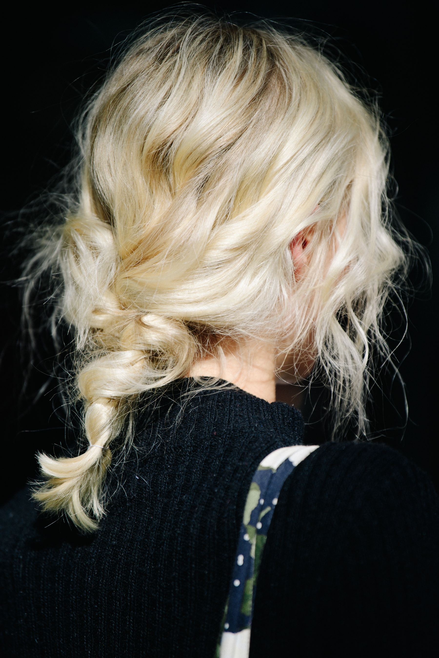 Woman with blonde hair tied back