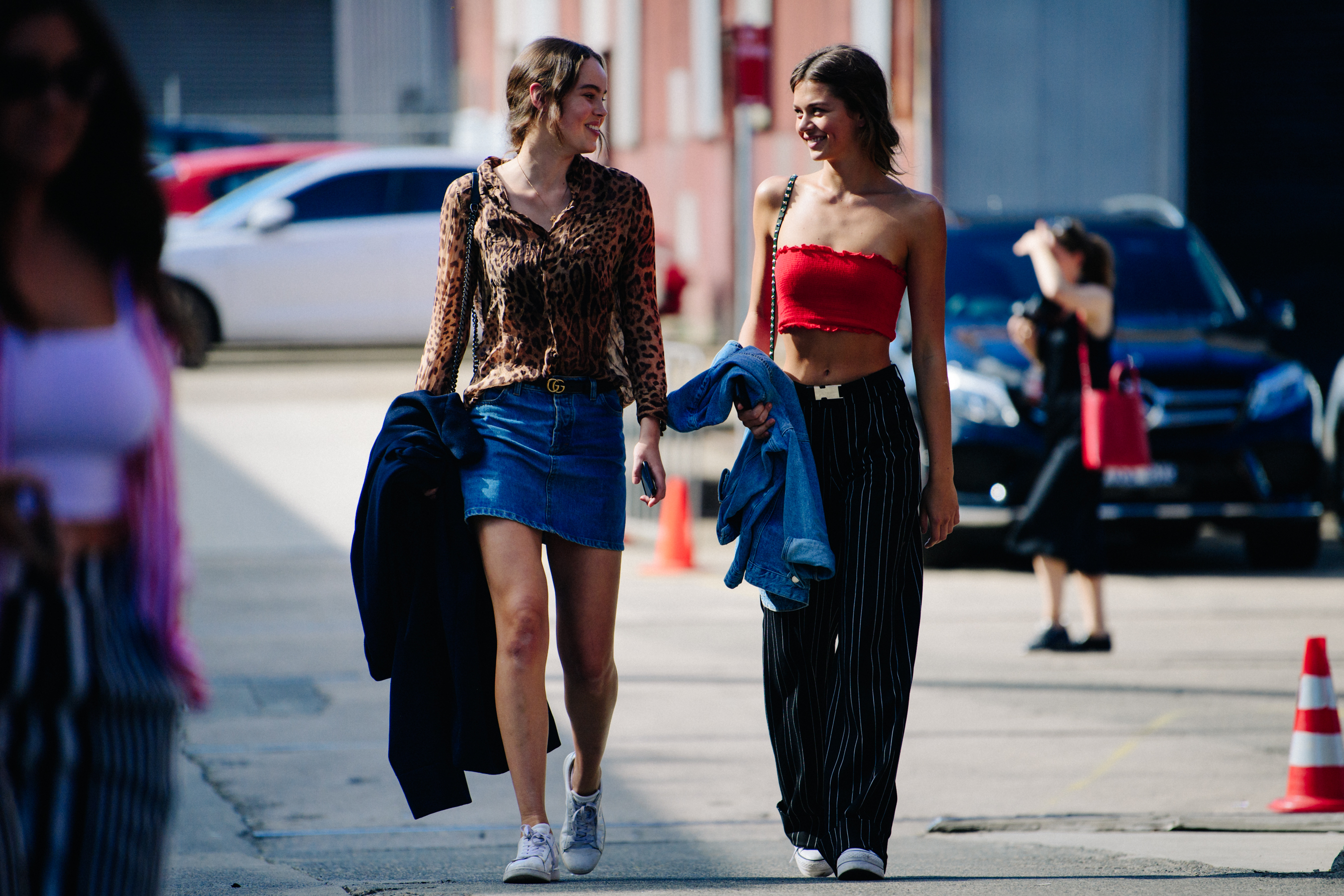 Two models wearing branded belts