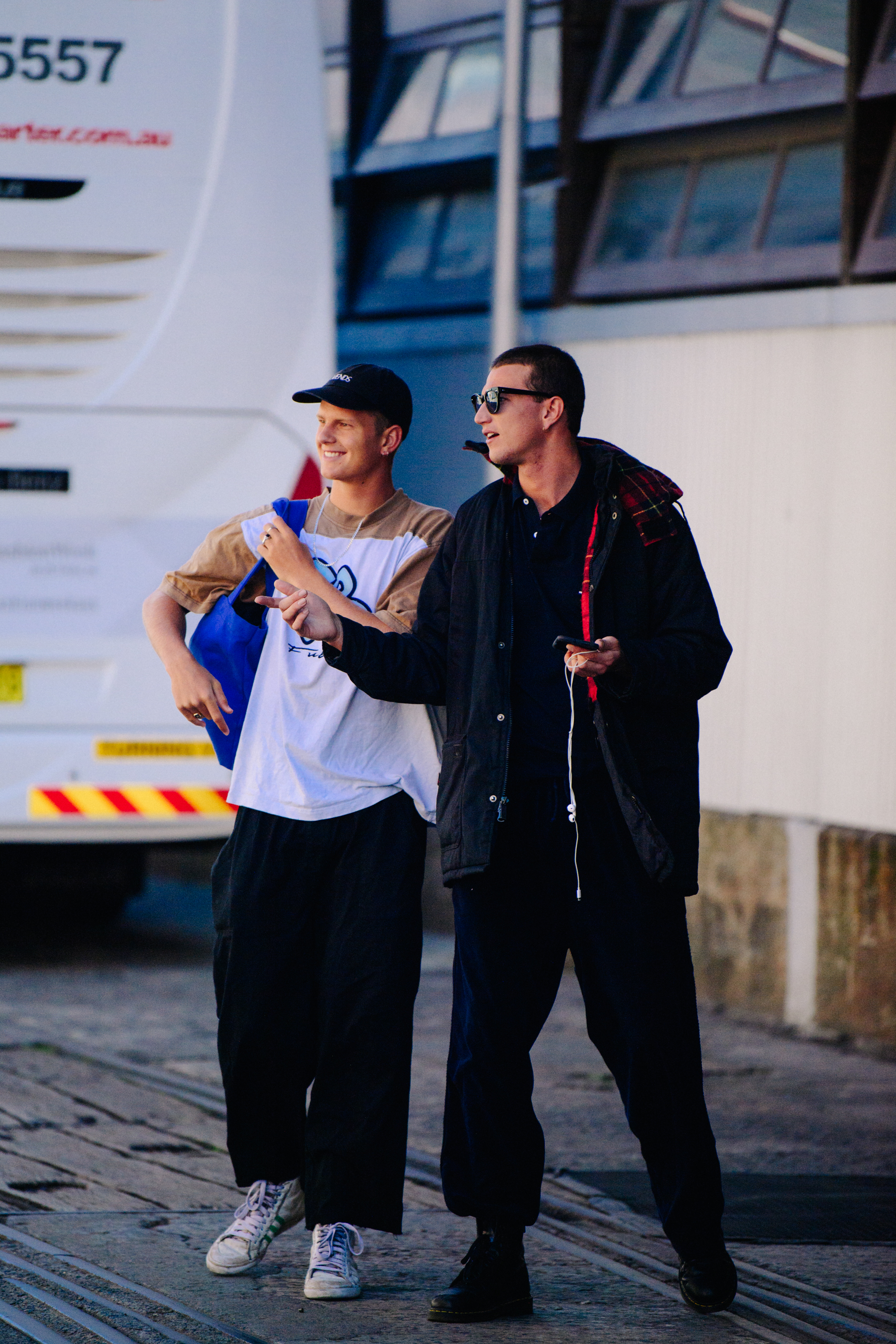 Two men wearing dark outfits