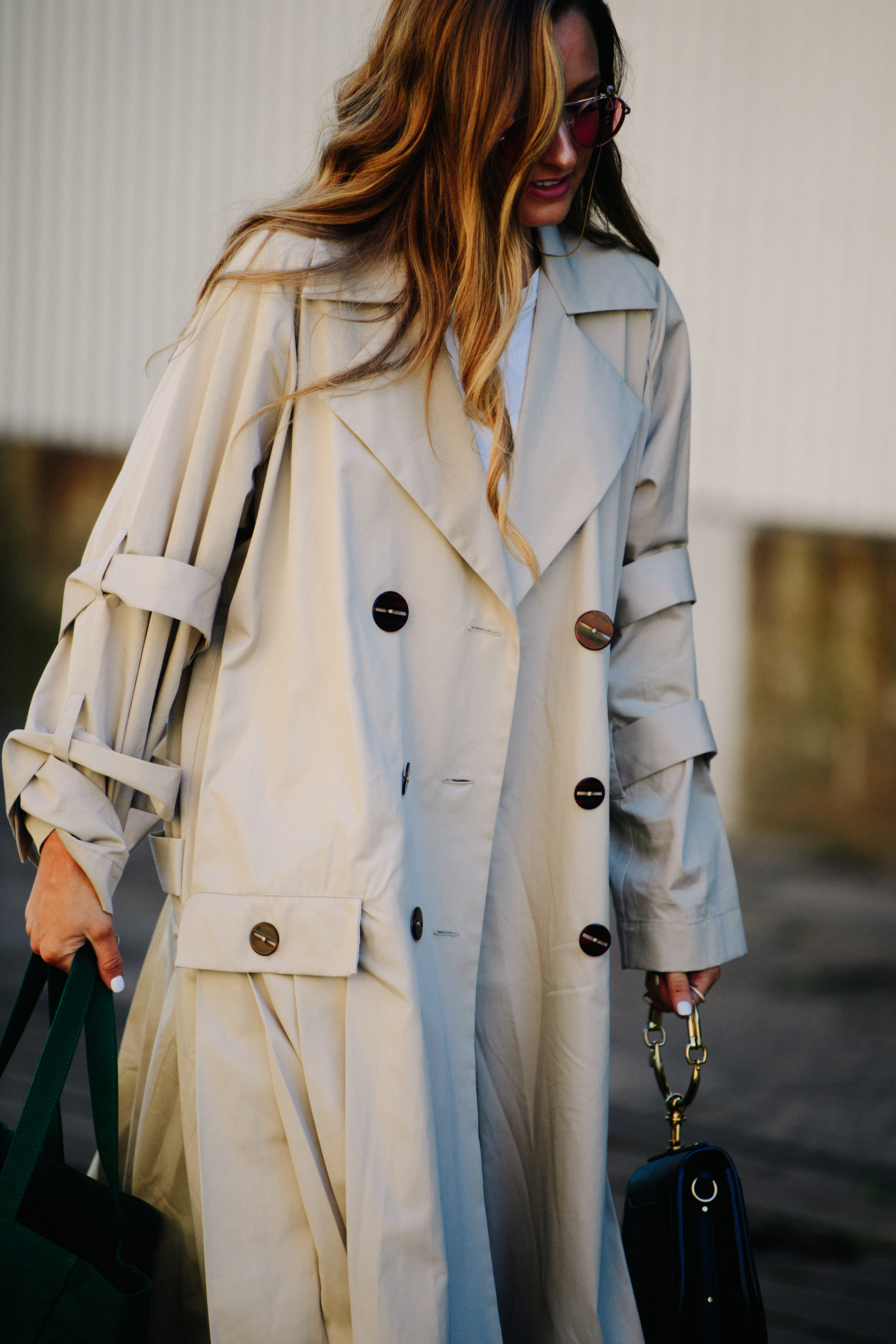 Woman wearing long cream coat