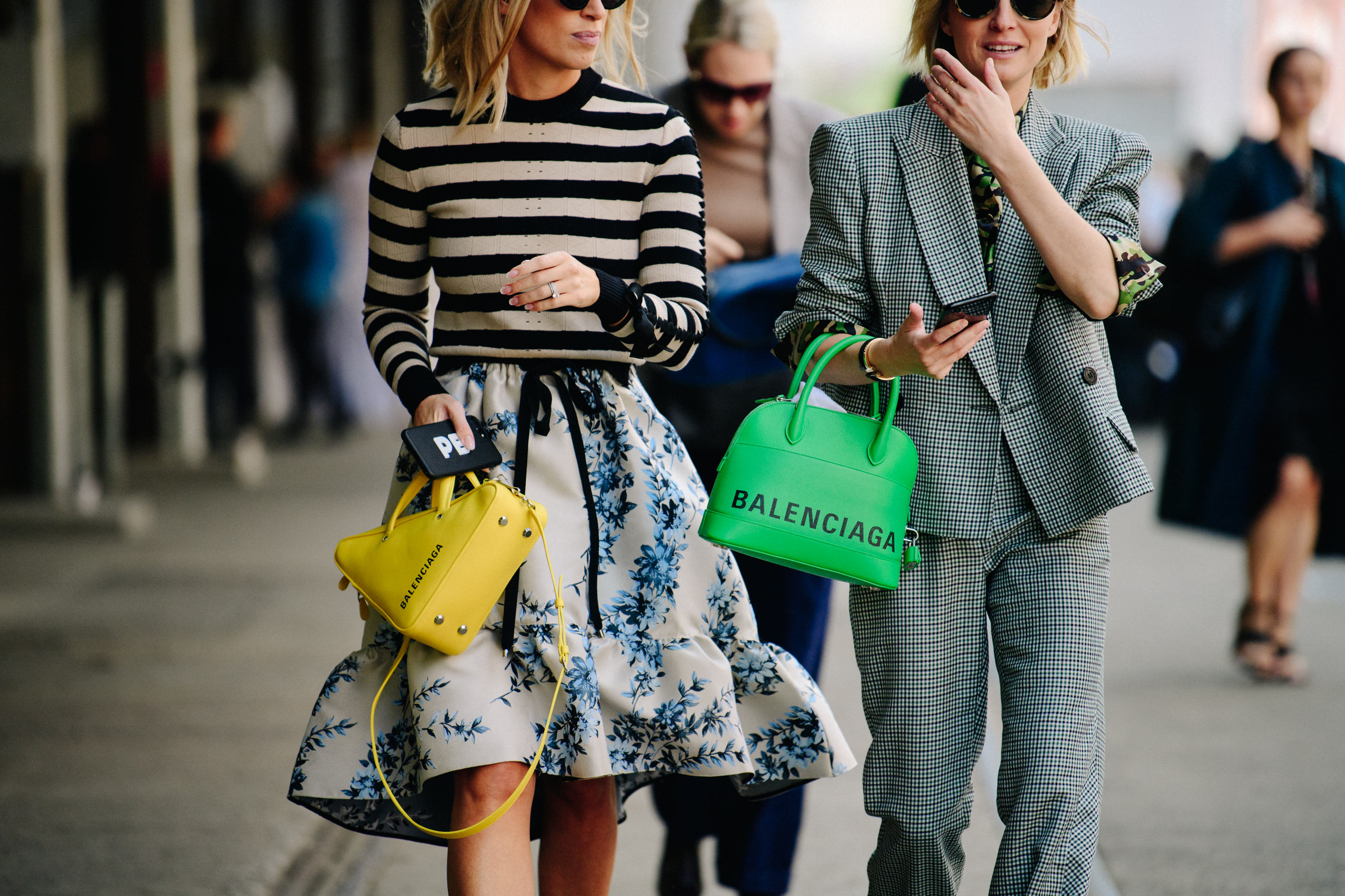 Two women carrying Balenciaga bags